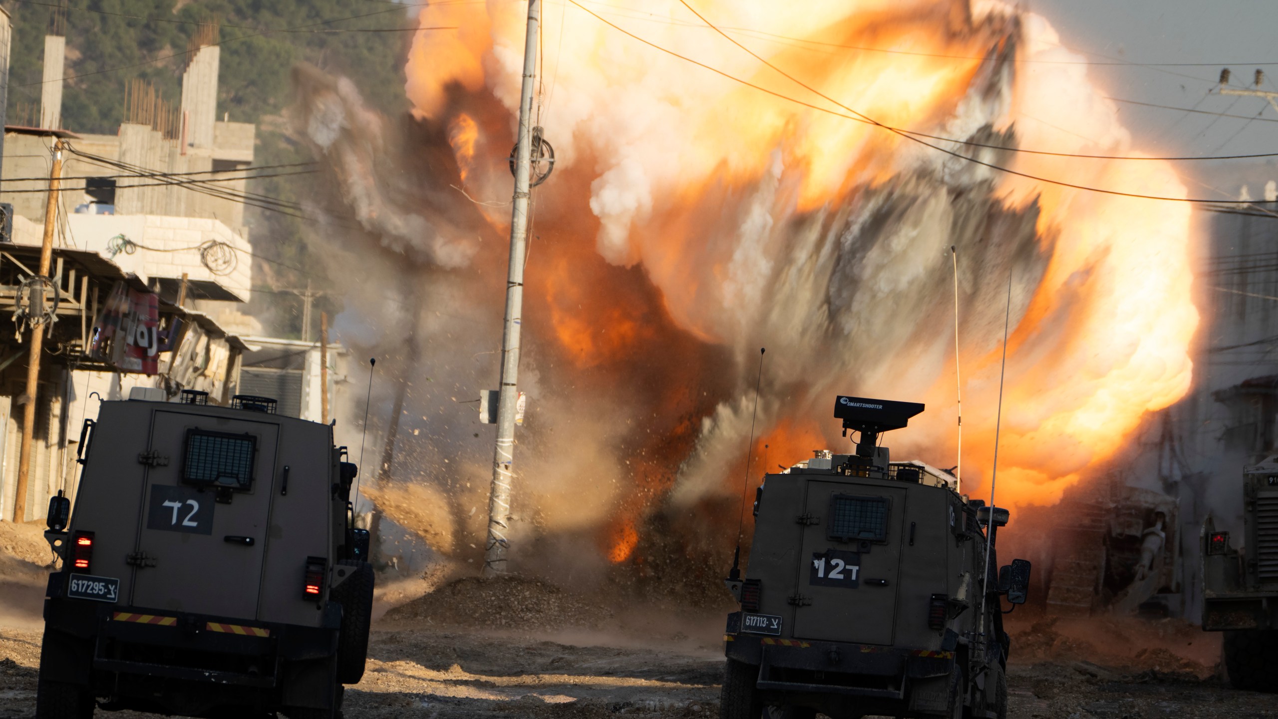 An explosive devise planted by Palestinian militants explodes after being detonated by Israeli soldiers during a military raid in the Nur Shams refugee camp near the West Bank city of Tulkarem, Tuesday, Dec. 24, 2024. (AP Photo/Majdi Mohammed)