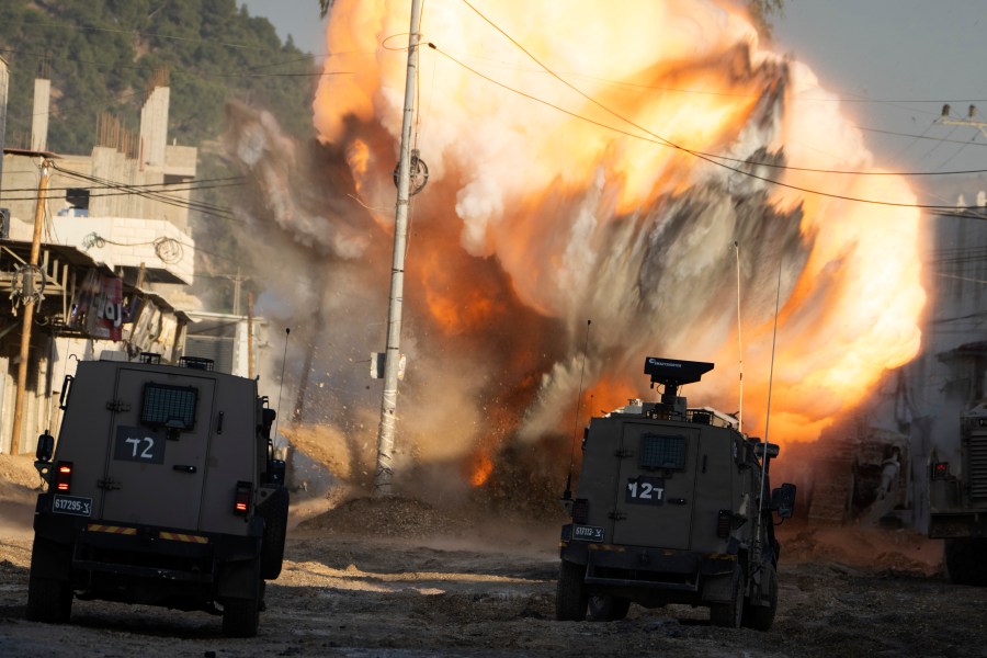 An explosive devise planted by Palestinian militants explodes after being detonated by Israeli soldiers during a military raid in the Nur Shams refugee camp near the West Bank city of Tulkarem, Tuesday, Dec. 24, 2024. (AP Photo/Majdi Mohammed)