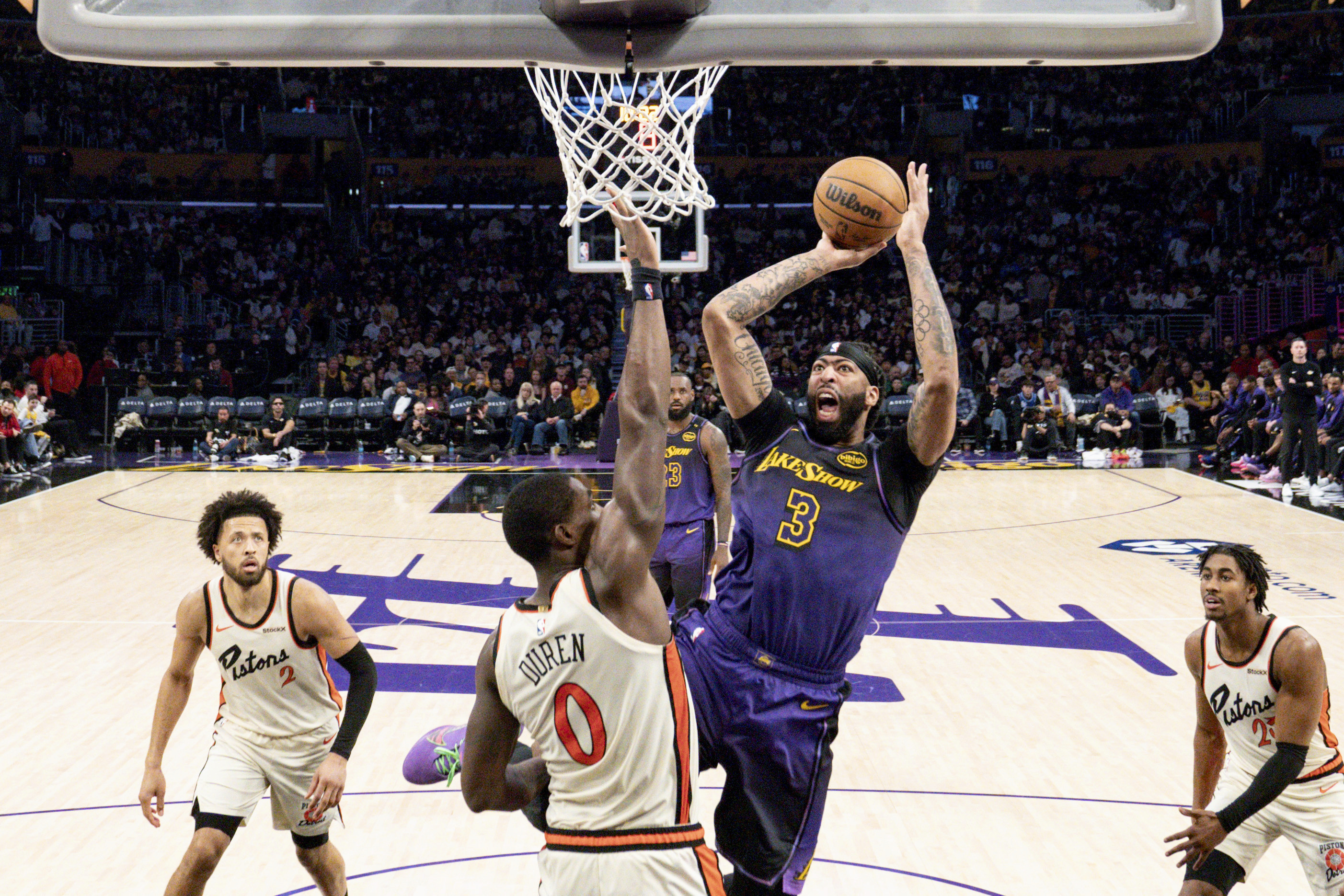 Los Angeles Lakers forward Anthony Davis (3) shoots over Detroit Pistons center Jalen Duren (0) during the second half of an NBA basketball game in Los Angeles, Monday, Dec. 23, 2024. (AP Photo/Eric Thayer)