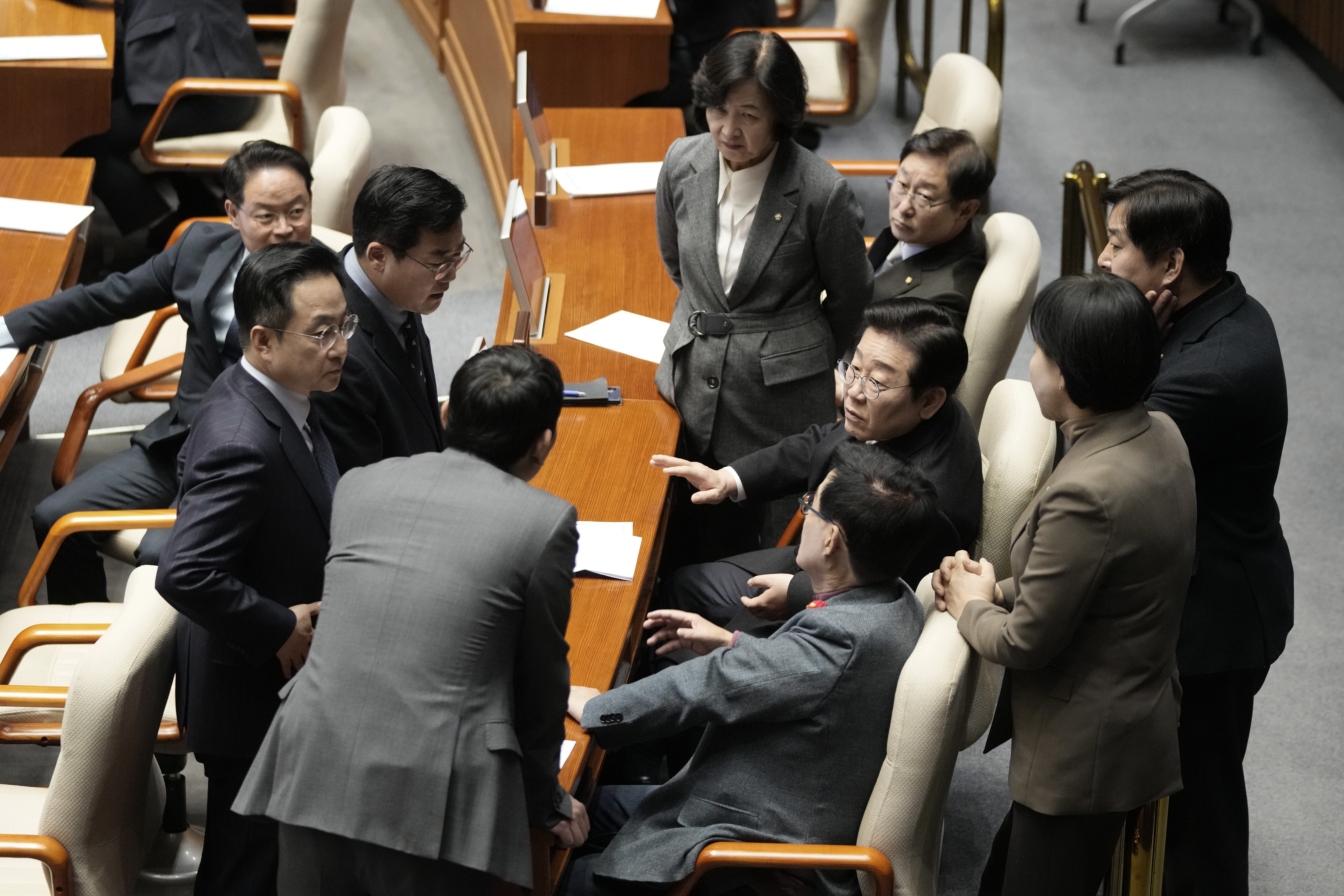 South Korea's main opposition Democratic Party leader Lee Jae-myung, third from right, talks with his party members during the plenary session at the National Assembly in Seoul, South Korea, Thursday, Dec. 26, 2024. (AP Photo/Ahn Young-joon)