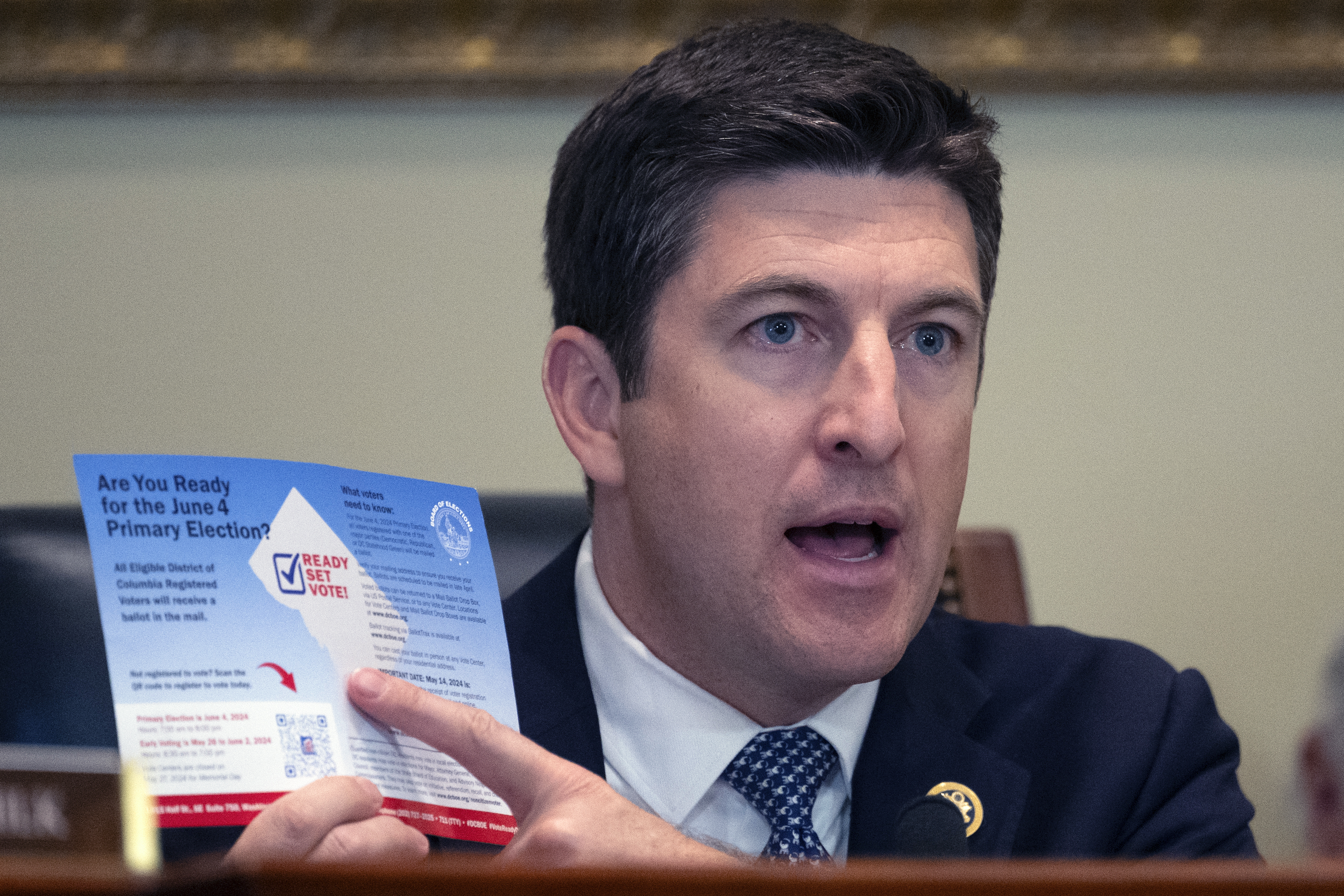 FILE - Bryan Steil, R-Wis., chairman of the Committee on House Administration, points to a election brochure for Washington, during a hearing he conducted about noncitizen voting on Capitol Hill, May 16, 2024 in Washington. (AP Photo/John McDonnell, File)