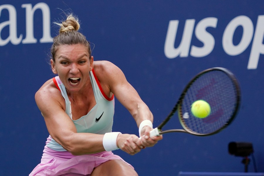 FILE - Simona Halep, of Romania, returns a shot to Daria Snigur, of Ukraine, during the first round of the U.S. Open tennis tournament, Aug. 29, 2022, in New York. (AP Photo/Seth Wenig, File)