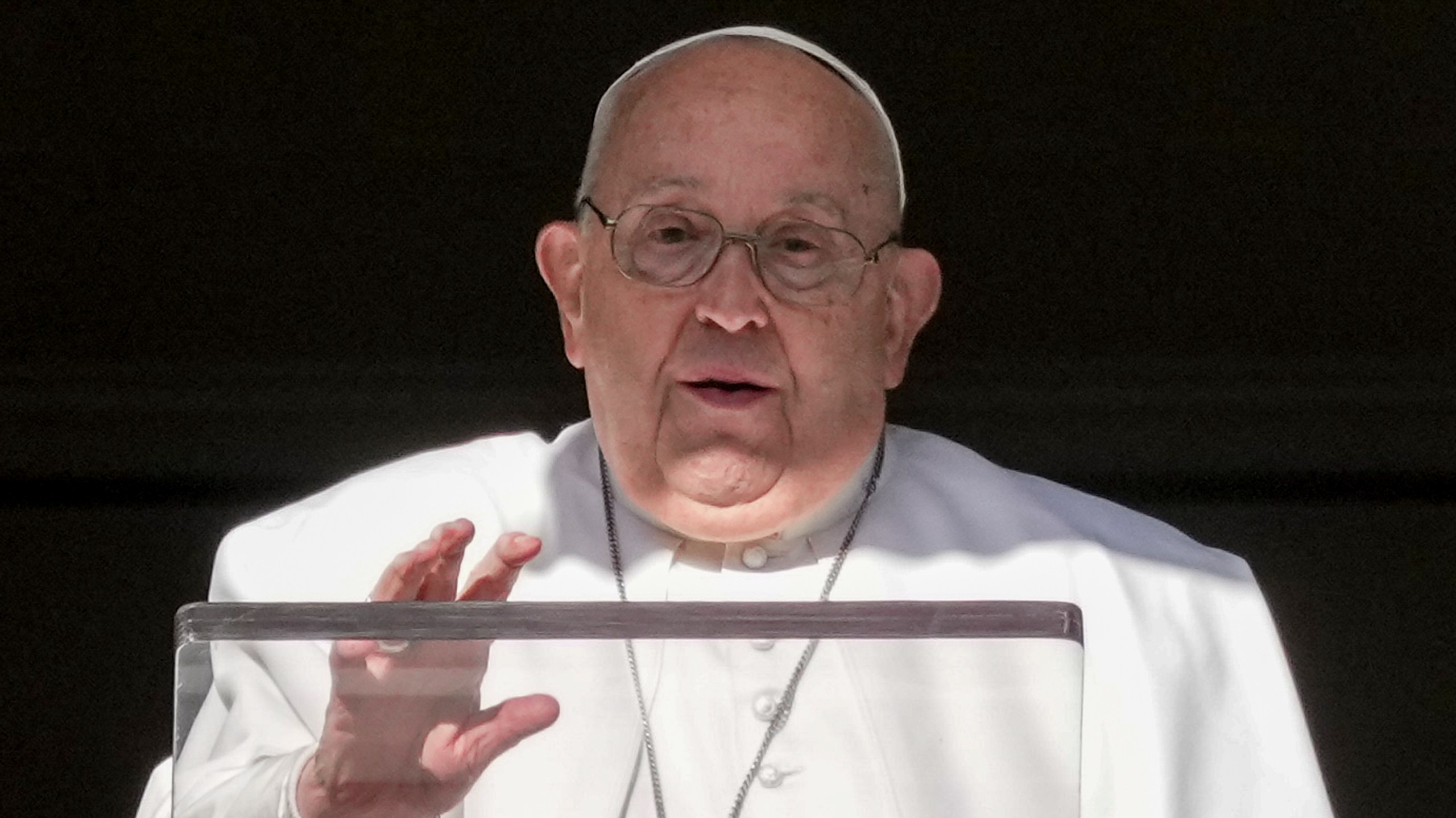 Pope Francis delivers his blessing as he recites the Angelus noon prayer from the window of his studio overlooking St.Peter's Square, at the Vatican, Thursday, Dec. 26, 2024. (AP Photo/Andrew Medichini)