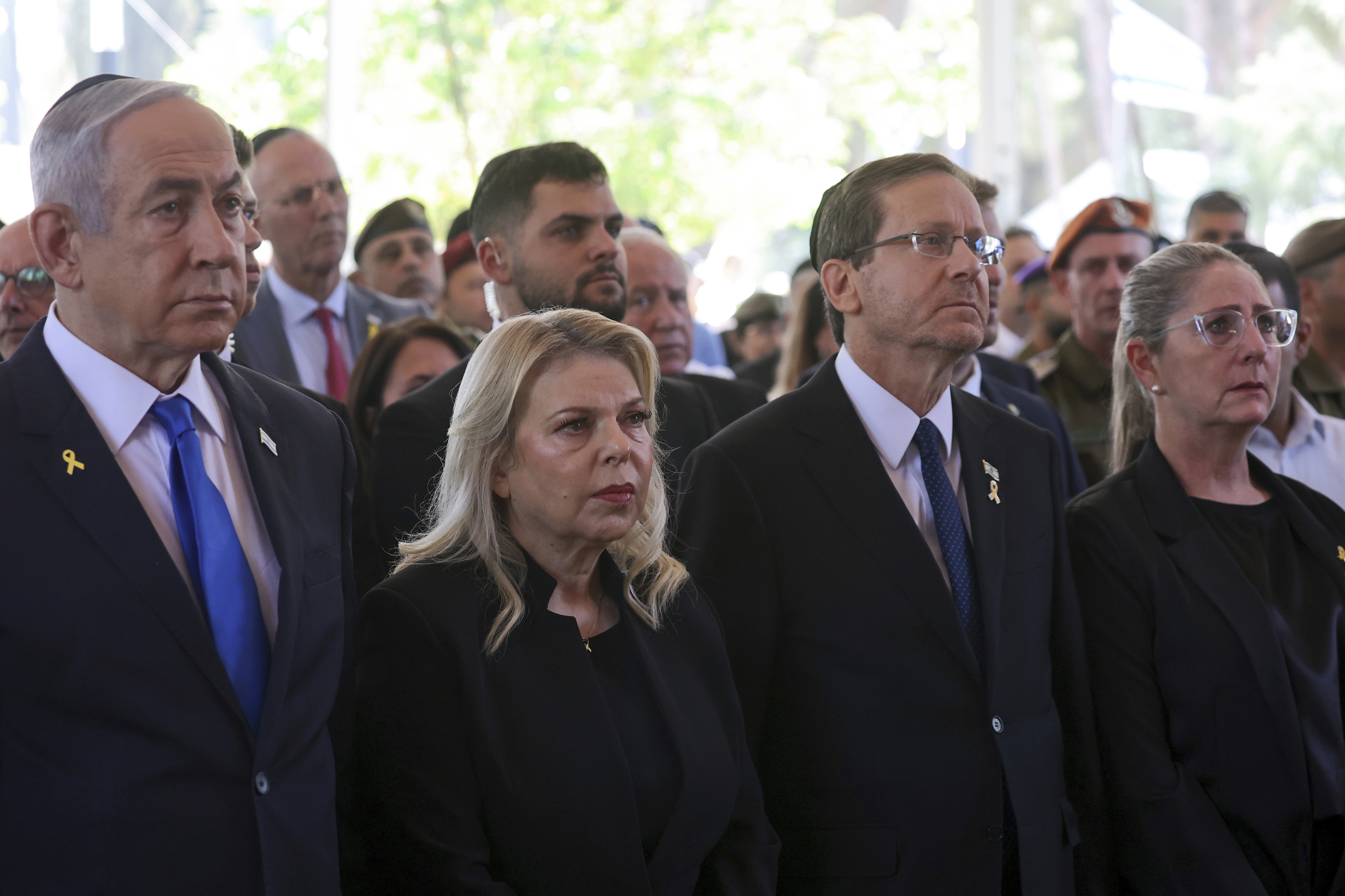 FILE - Israel's Prime Minister Benjamin Netanyahu, from left, his wife Sara Netanyahu, President Isaac Herzog and First Lady Michal Herzog, attend a ceremony marking the Hebrew calendar anniversary of the Hamas attack on October 7 2023 that sparked the ongoing war in Gaza, at the Mount Herzl military cemetery in Jerusalem, Israel, Oct. 27, 2024. (Gil Cohen-Magen/Pool Photo via AP, File)