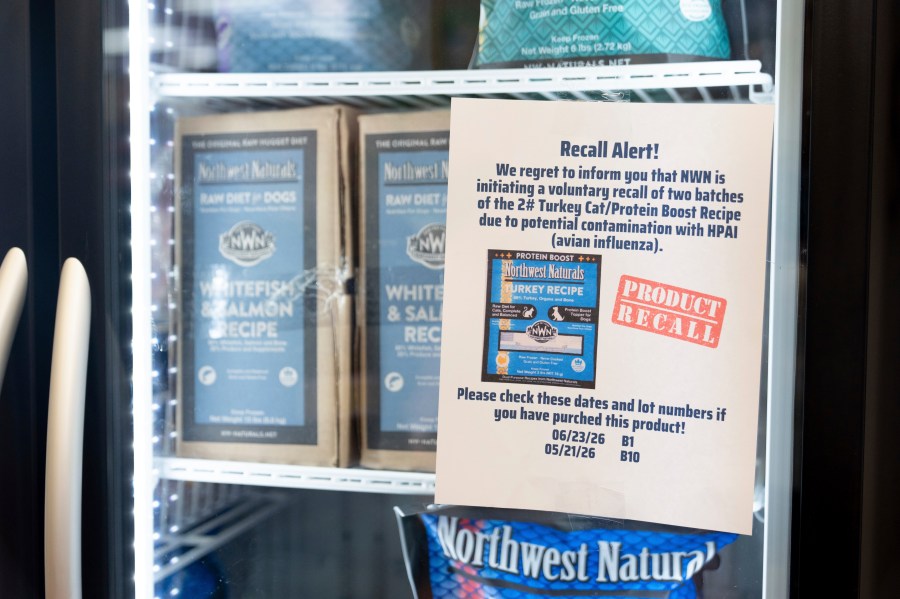 A recall alert is displayed on a refrigerator at a pet store in Tigard, Ore., on Thursday, Dec. 26, 2024, after Northwest Naturals announced a voluntary recall Tuesday of one batch of its 2-pound Feline Turkey Recipe raw frozen pet food after it tested positive for the virus. (AP Photo/Jenny Kane)