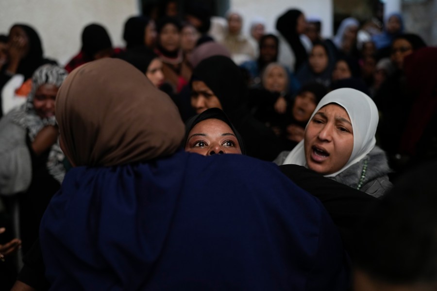 A mourner cries after taking a last look at the body of a relative, one of eight Palestinians killed, during their funeral following the withdrawal of the Israeli army, in the West Bank city of Tulkarem, Thursday, Dec. 26, 2024. (AP Photo/Matias Delacroix)