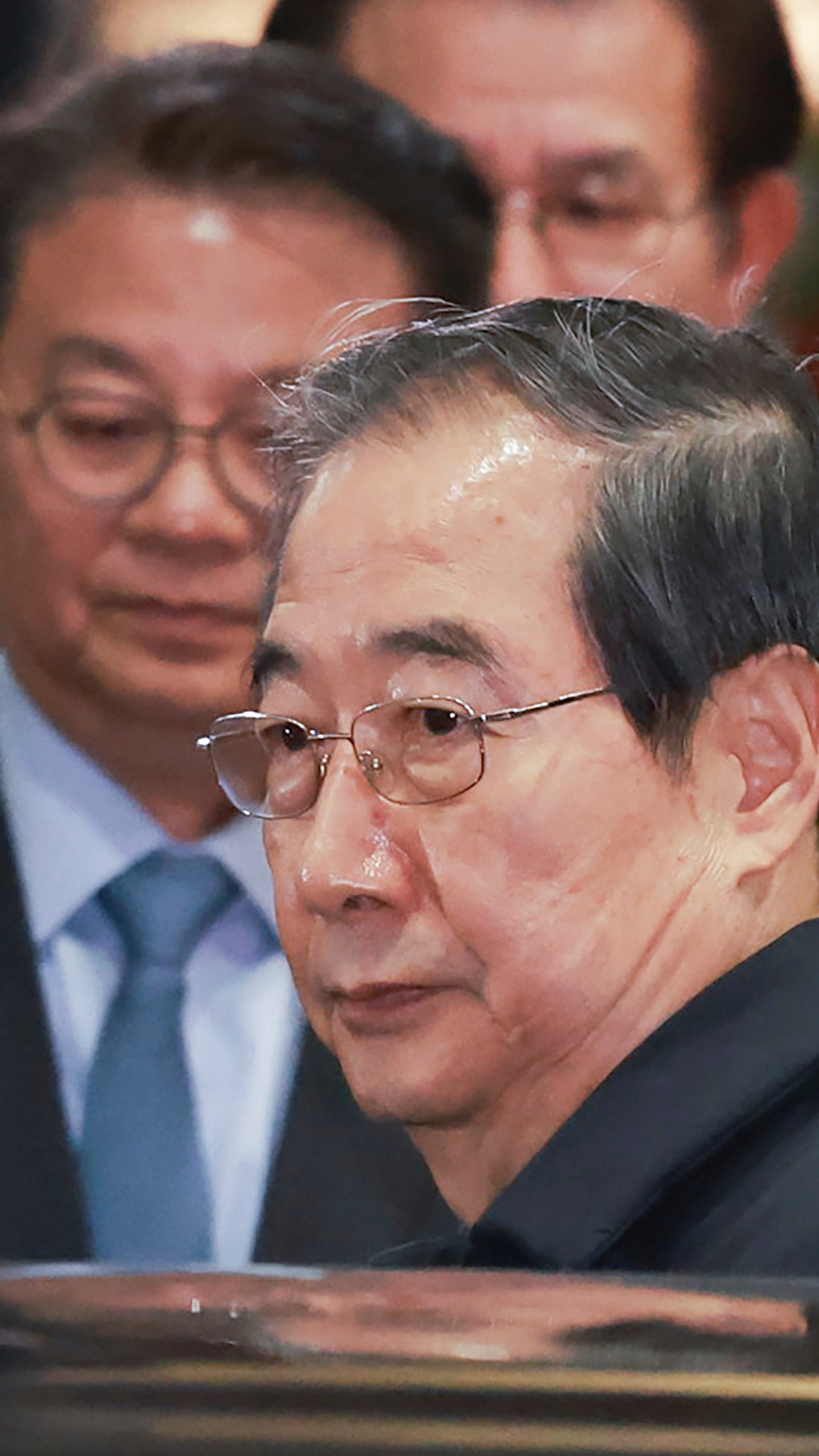 Impeached South Korean acting President Han Duck-soo gets into a car as he leaves the government complex building in Seoul, South Korea, Friday, Dec. 27, 2024. (Hong Hae-in/Yonhap via AP)