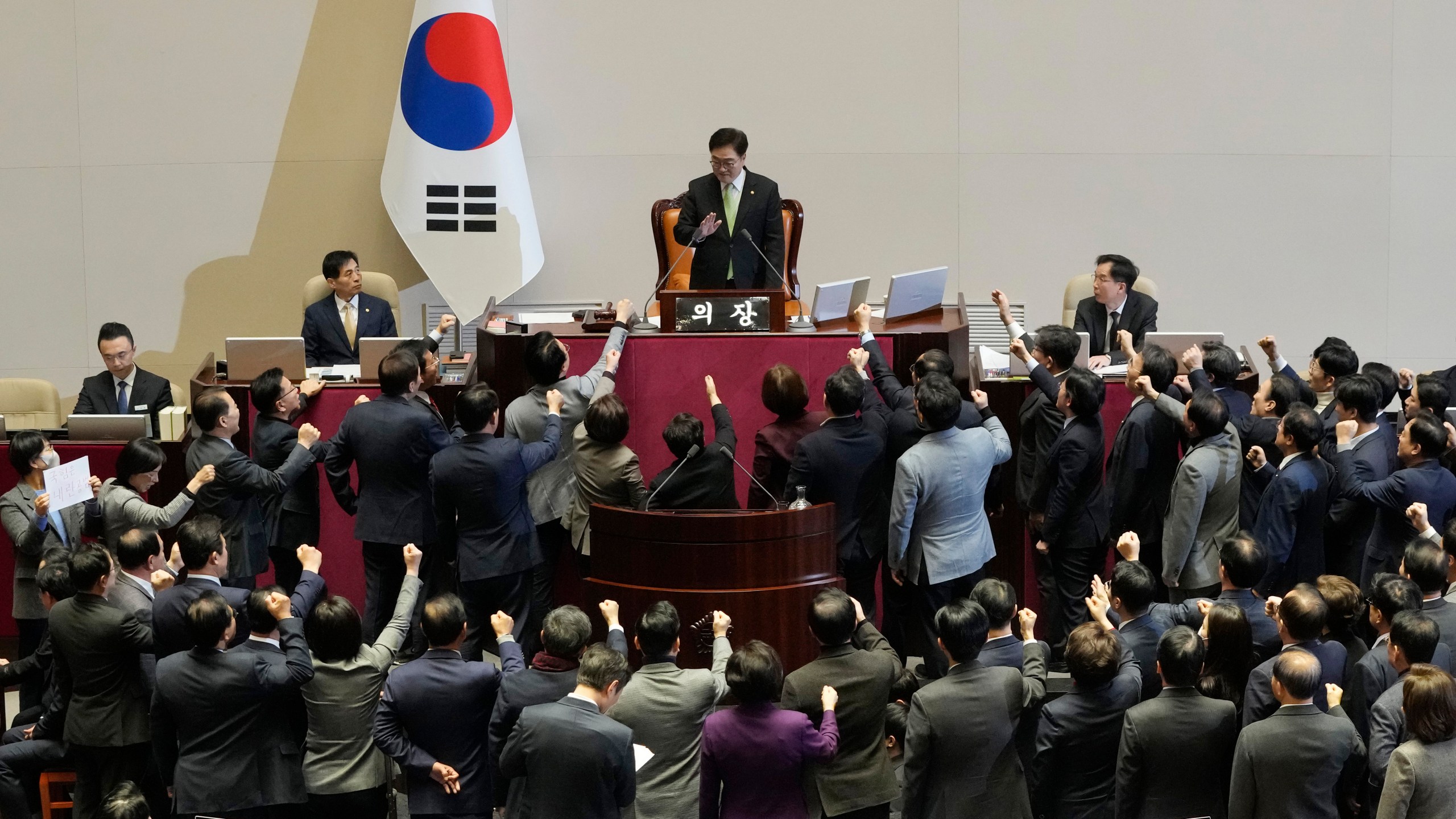 Lawmakers of the ruling People Power Party protest to South Korea's National Assembly Speaker Woo Won Shik, top center, during a plenary session for the impeachment motion against South Korean acting President Han Duck-soo at the National Assembly in Seoul, South Korea, Friday Dec. 27, 2024. (AP Photo/Ahn Young-joon)