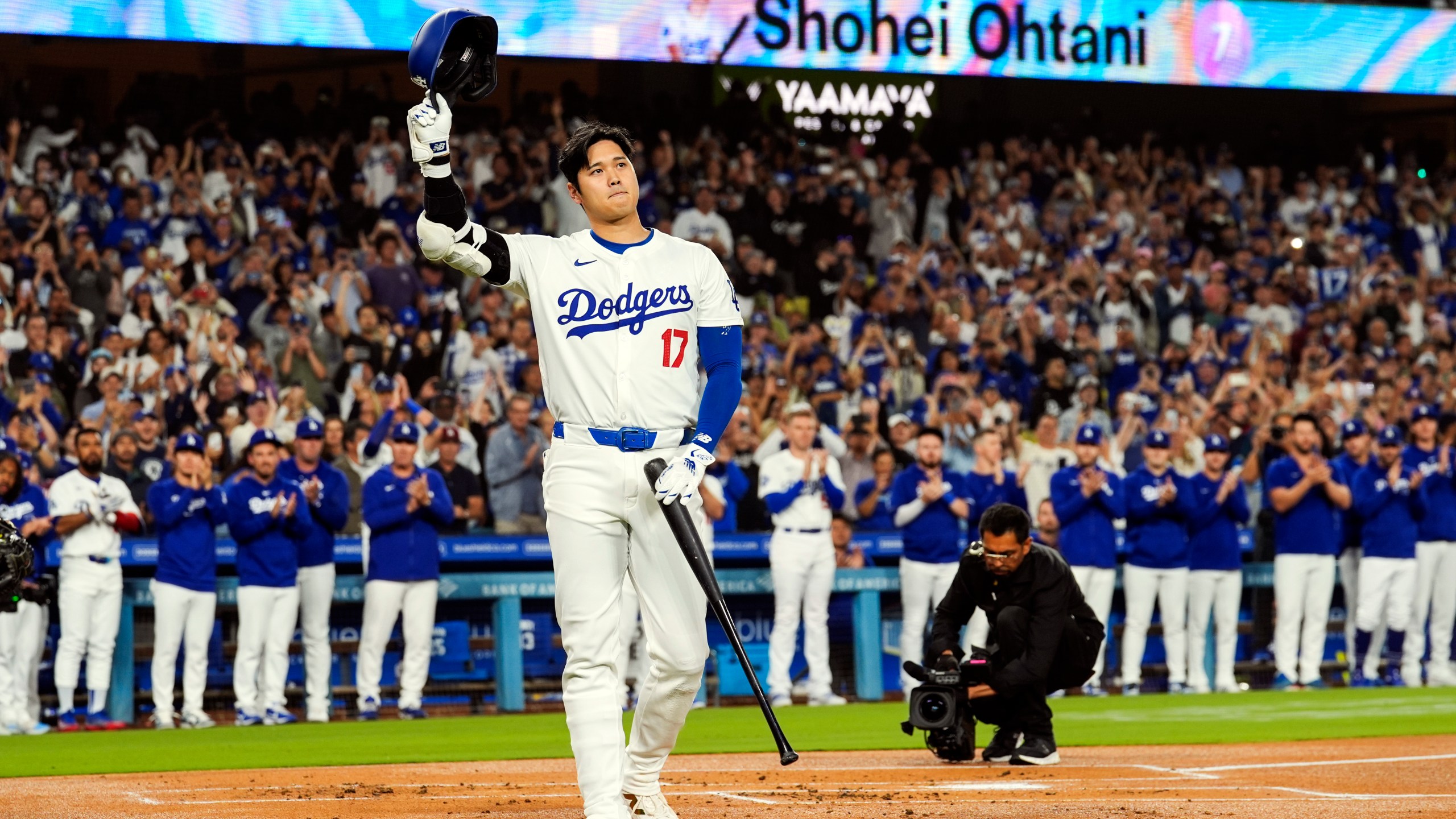 FILE - Los Angeles Dodgers designated hitter Shohei Ohtani (17) is honored for being first MLB player to achieve 50 home runs and 50 stolen bases in a single season during the first inning of a baseball game against the Colorado Rockies in Los Angeles, Friday, Sept. 20, 2024. (AP Photo/Ashley Landis, File)