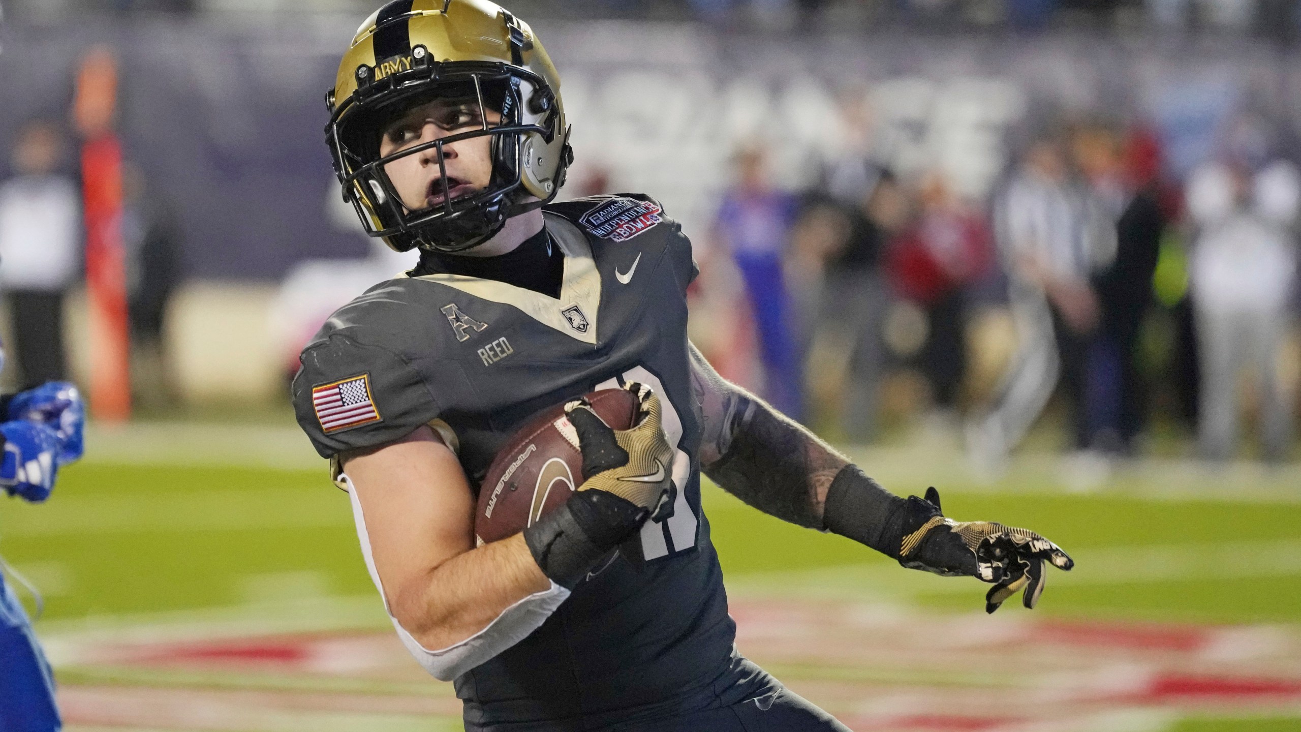 Army running back Hayden Reed looks back while on a touchdown run against Louisiana Tech during the first half of the Independence Bowl NCAA college football game, Saturday Dec. 28, 2024, in Shreveport, La. (AP Photo/Rogelio V. Solis)