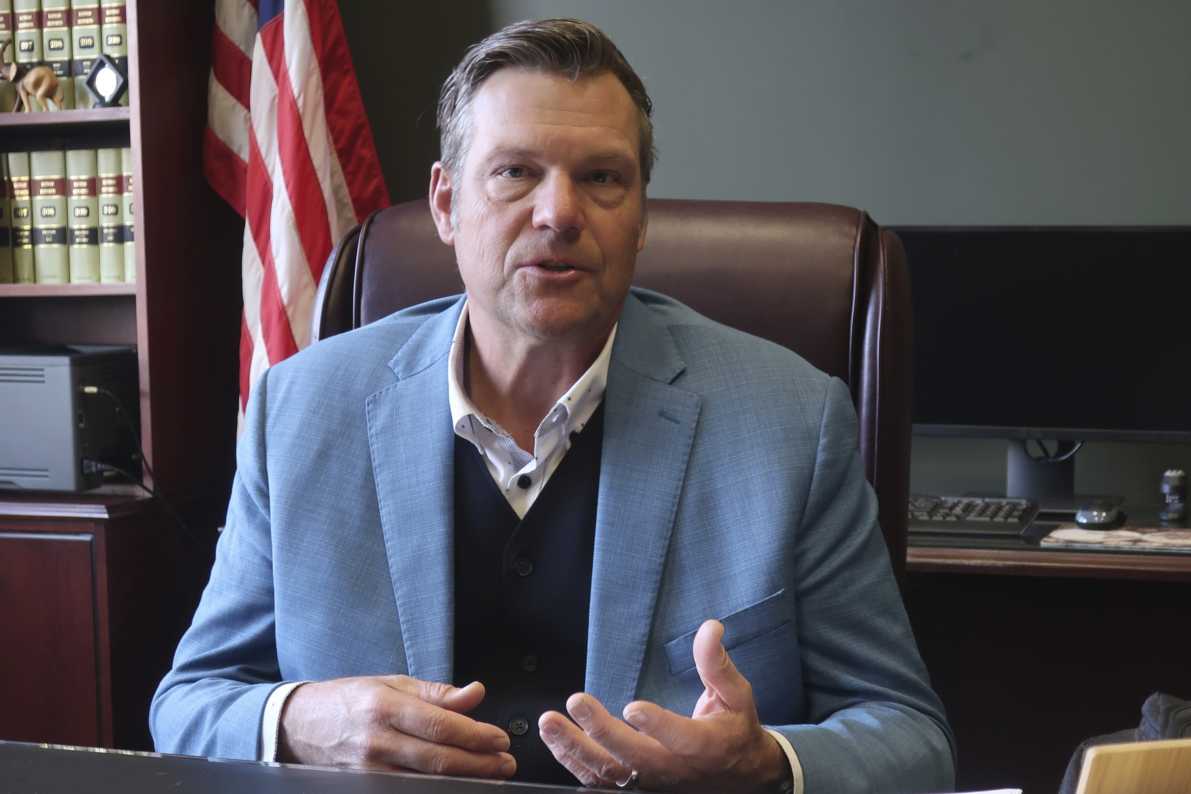 Kansas Attorney General Kris Kobach, a strong support of requiring new voters to provide proof of their U.S. citizenship when registering, answers questions during an interview with The Associated Press, Wednesday, Dec. 18, 2024, in his office in Topeka, Kan. (AP Photo/John Hanna)