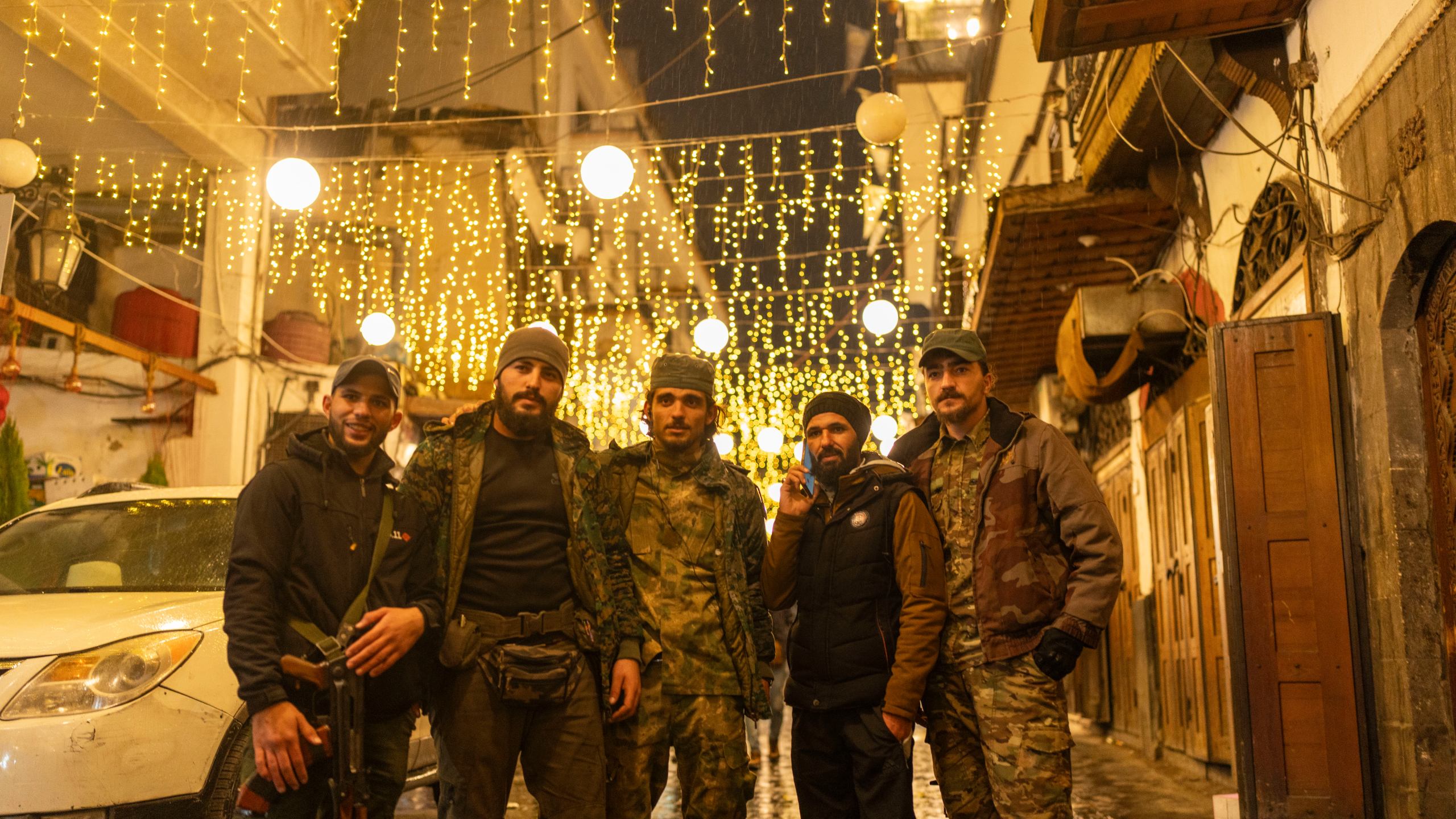 Members of the HTS rebel group that overthrew the Assad regime pose for a portrait in the ancient town of old Damascus, in Syria, Saturday, Dec. 28, 2024 (AP Photo/Mosa'ab Elshamy)