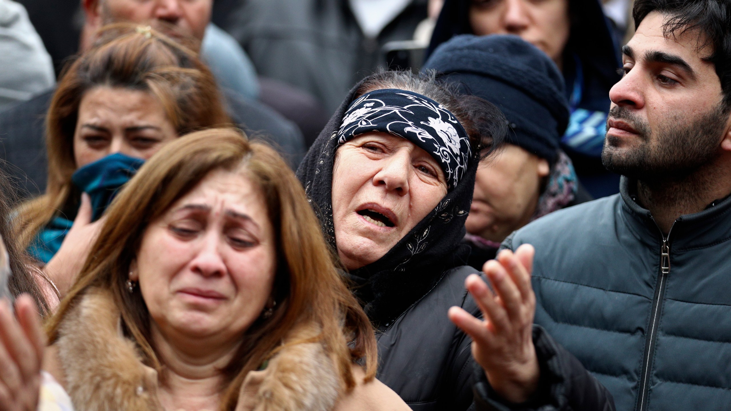 People mourn during a funeral of the crew members of the Azerbaijan Airlines Embraer 190 killed in a deadly plane crash in Kazakhstan this week, at the II Alley of Honor in Baku, Azerbaijan, Sunday, Dec. 29, 2024. (AP photo)