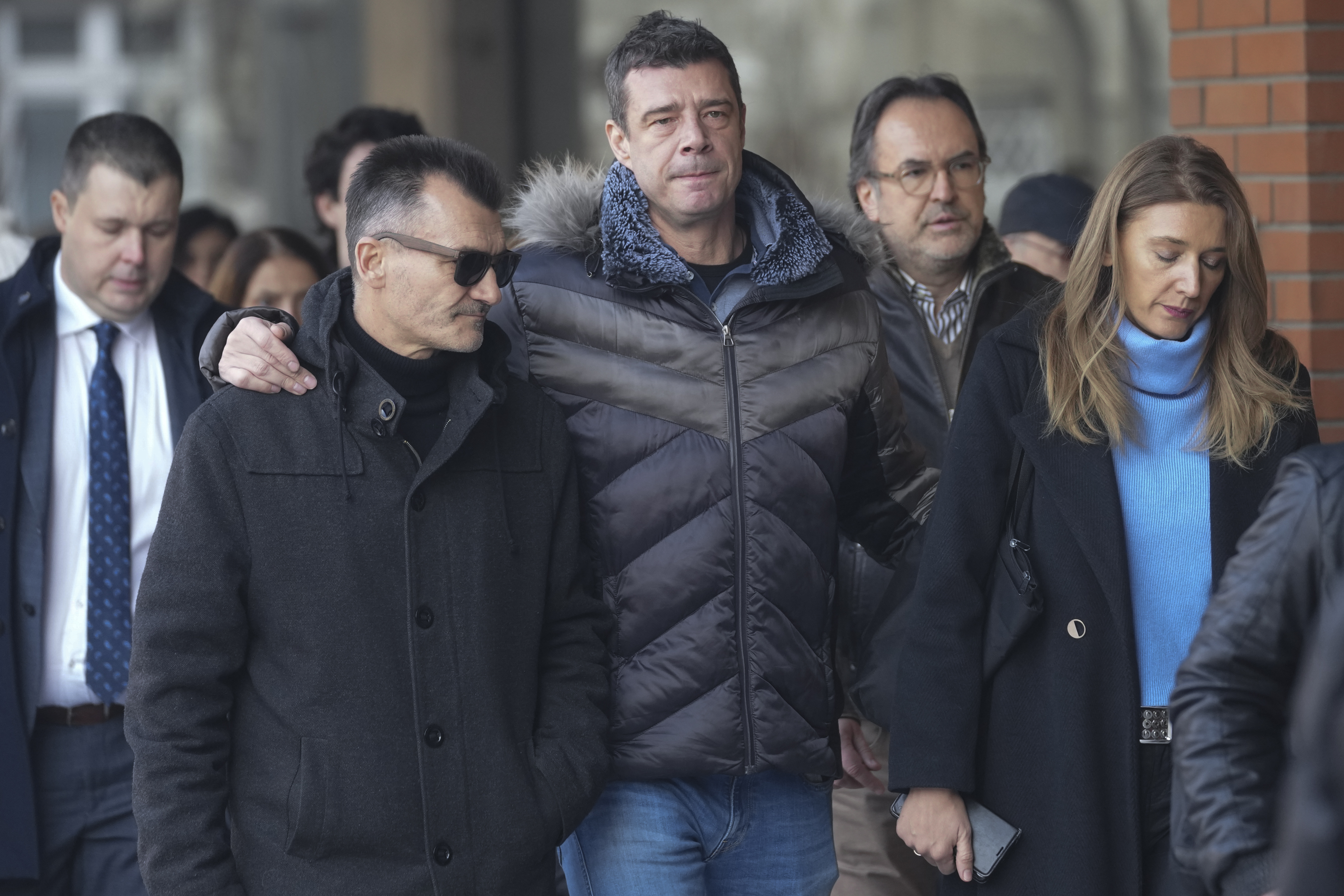 Relatives and friends of victims arrive in the court building prior to a verdict in trial of parents of a boy who killed 9 students and security guard in school shooting in 2023, in Belgrade, Serbia, Monday, Dec. 30, 2024. (AP Photo/Darko Vojinovic)