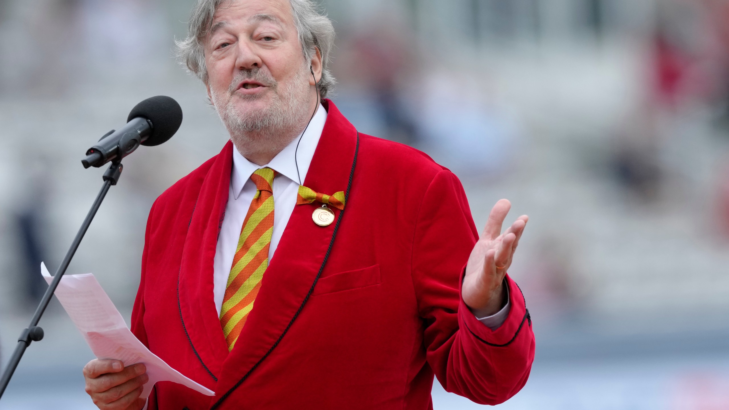 FILE - Stephen Fry, President of Marylebone Cricket Club, MCC, speaks on Red for Ruth Day, before the start of day two of the second Ashes Test cricket match at Lord's Cricket Ground, London, England, Thursday, June 29, 2023. (AP Photo/Kirsty Wigglesworth, File)