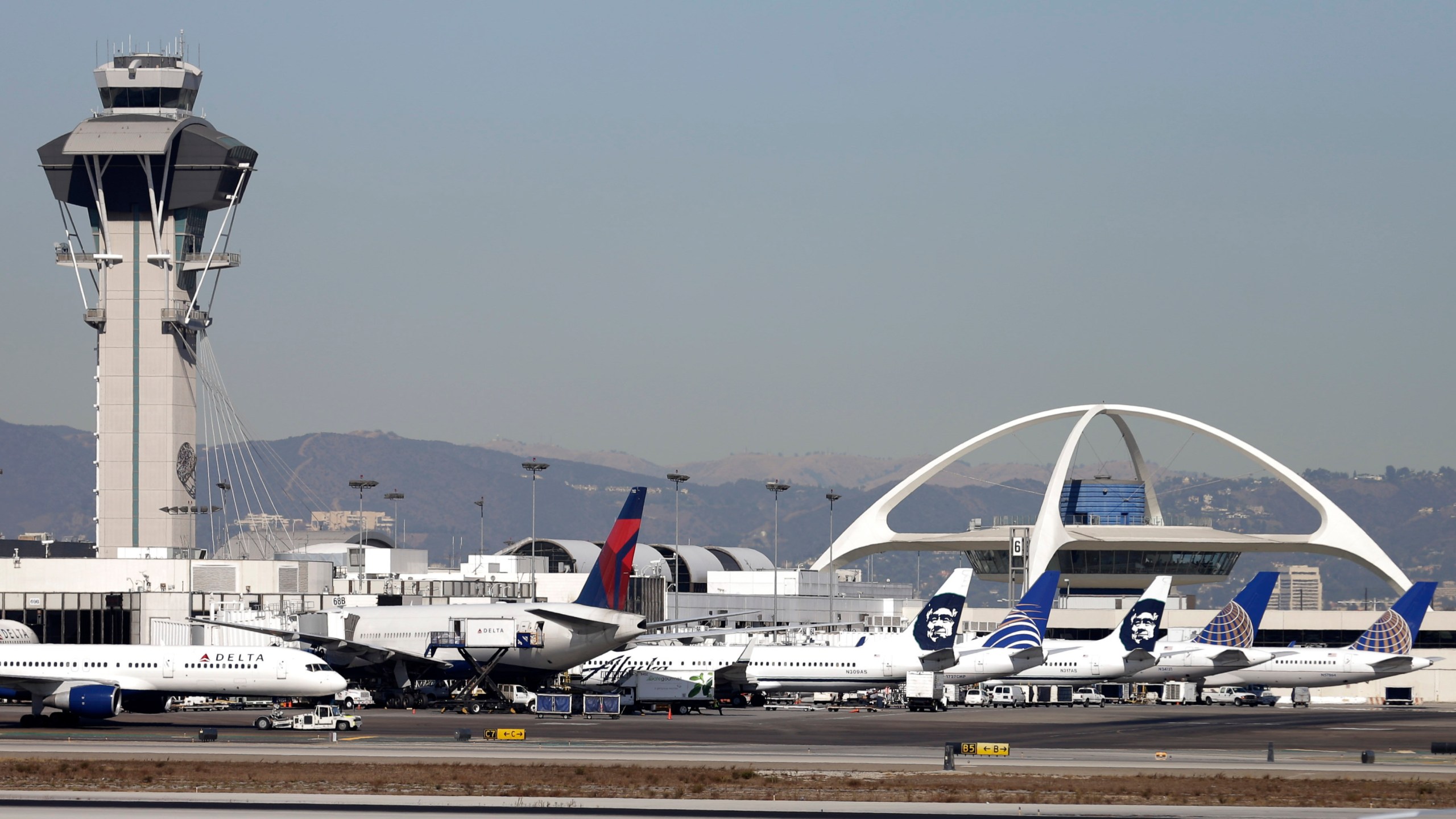 FILE - Airplanes sit on the tarmac at Los Angeles International Airport Friday, Nov. 1, 2013. (AP Photo/Gregory Bull, File)