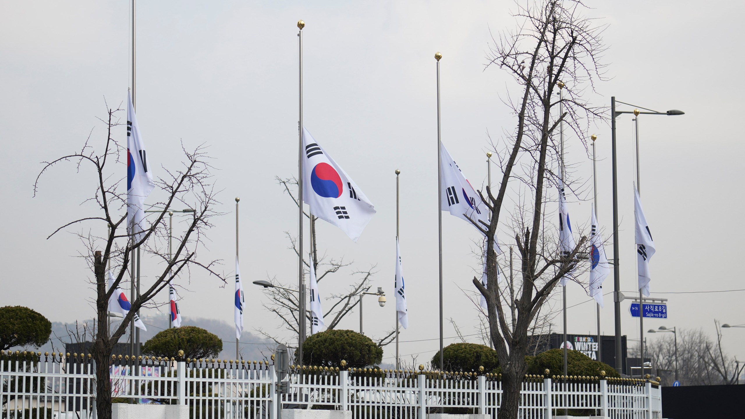 South Korean national flags fly at half-staff at a government complex in Seoul, South Korea, Monday, Dec. 30, 2024, a day after a jetliner skidded off a runway, slammed into a concrete fence and burst into flames at an airport the town of Muan. (AP Photo/Lee Jin-man)