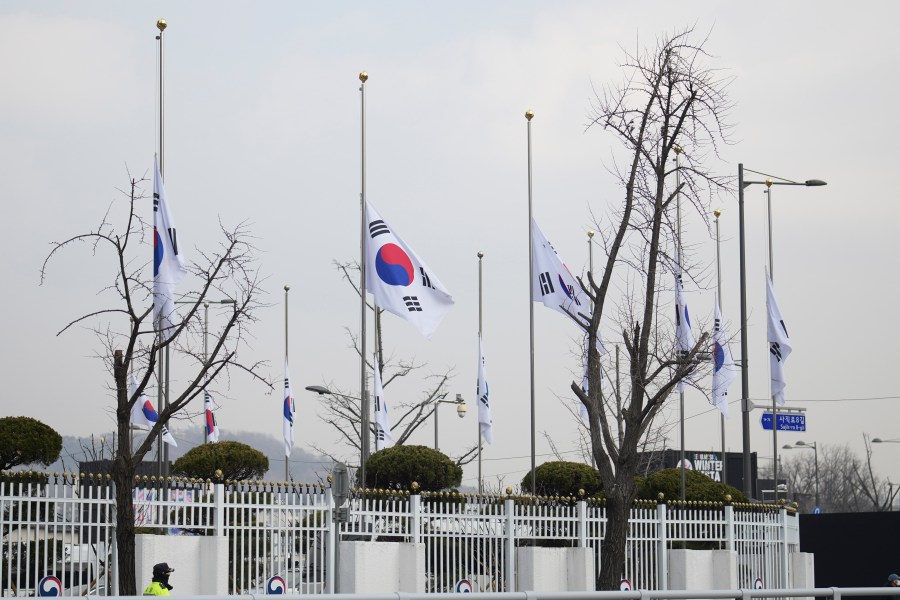 South Korean national flags fly at half-staff at a government complex in Seoul, South Korea, Monday, Dec. 30, 2024, a day after a jetliner skidded off a runway, slammed into a concrete fence and burst into flames at an airport the town of Muan. (AP Photo/Lee Jin-man)