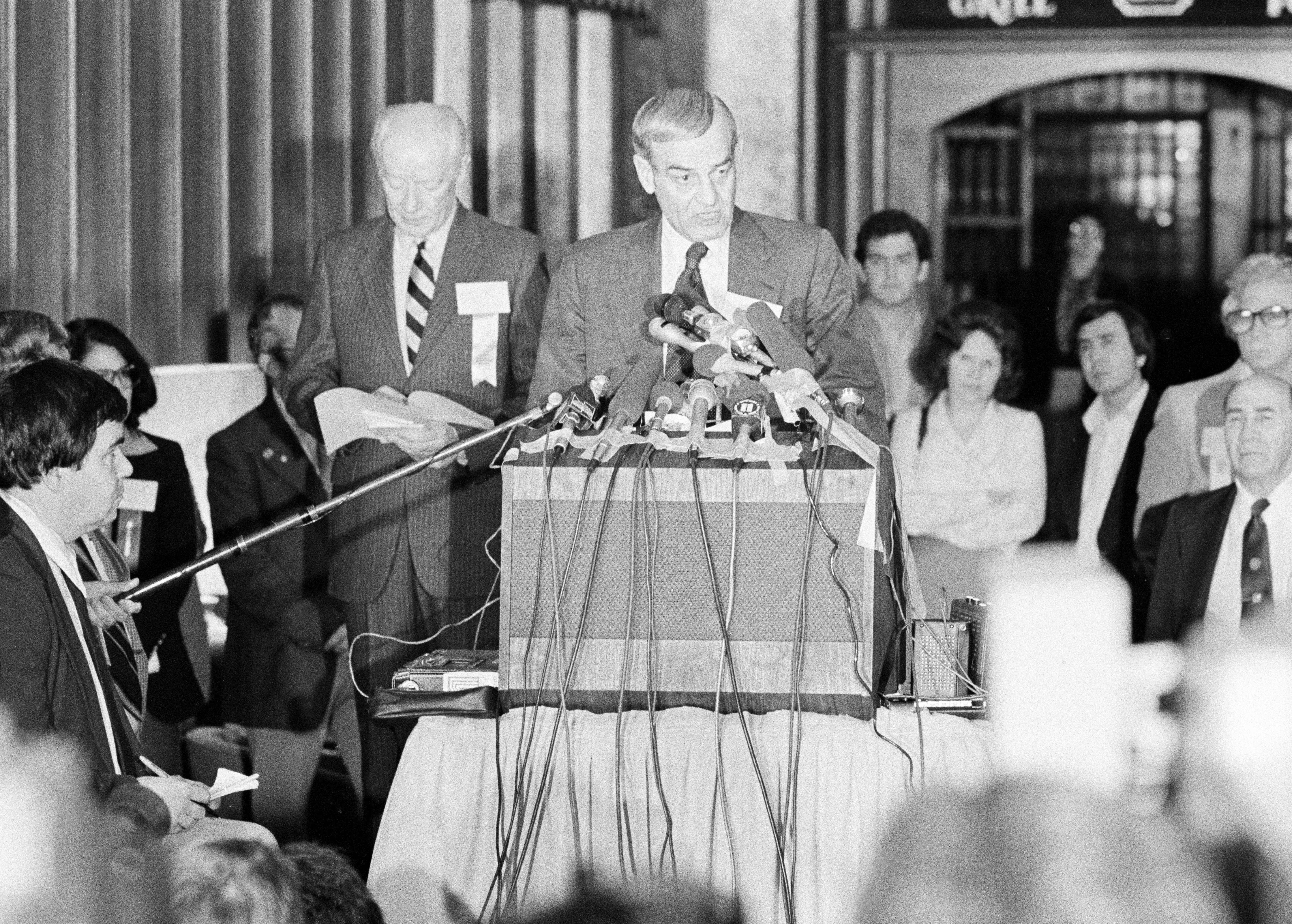 FILE - F. Don Miller, executive director of the U.S. Olympic Committee, reads a resolution adopted by the U.S. Olympic Committee's House of Delegates to boycott the 1980 Summer Games in Moscow, in Colorado Springs, Colo., April 12, 1980. At left is Robert Kane, president of the U.S. Olympic Committee. (AP Photo/Ed Andrieski, File)