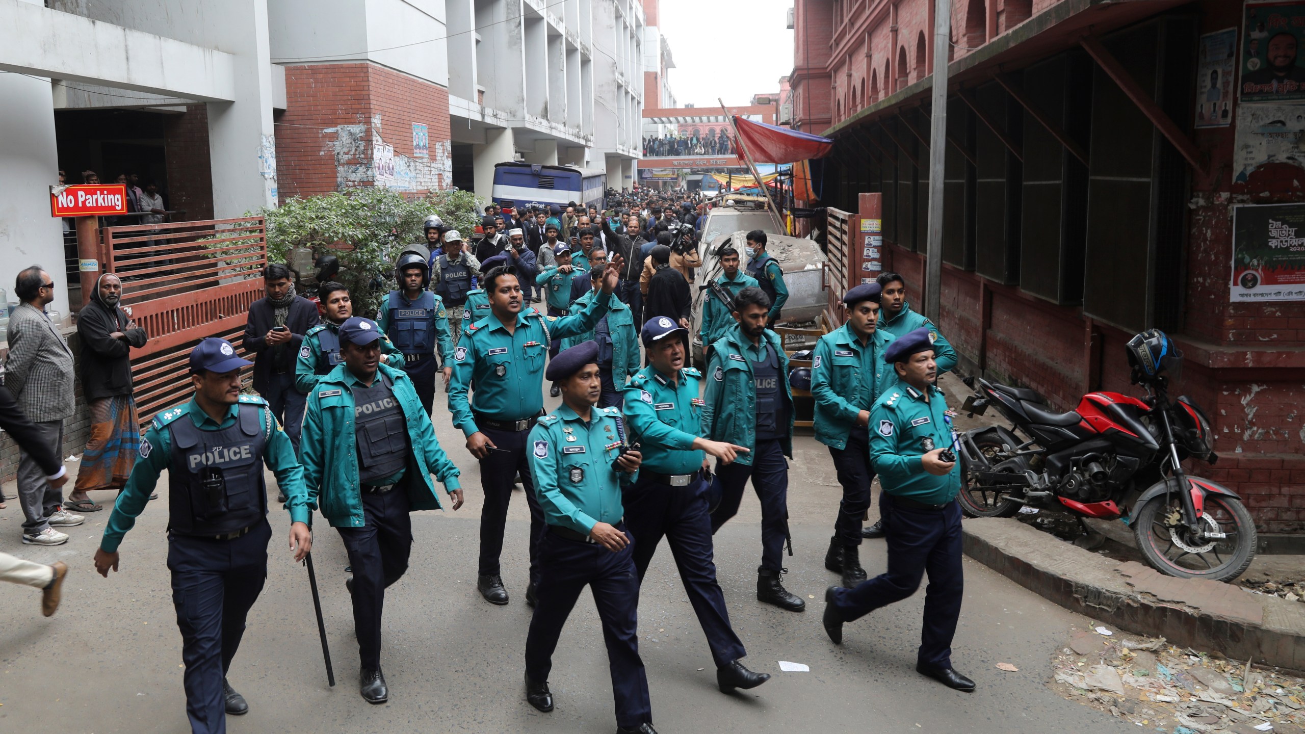 Police officials clear the way for the vehicle carrying Krishna Das Prabhu, a jailed Hindu leader, after a court rejected his plea for bail, in Chattogram, Bangladesh, Thursday, Jan. 2, 2025. (AP Photo)