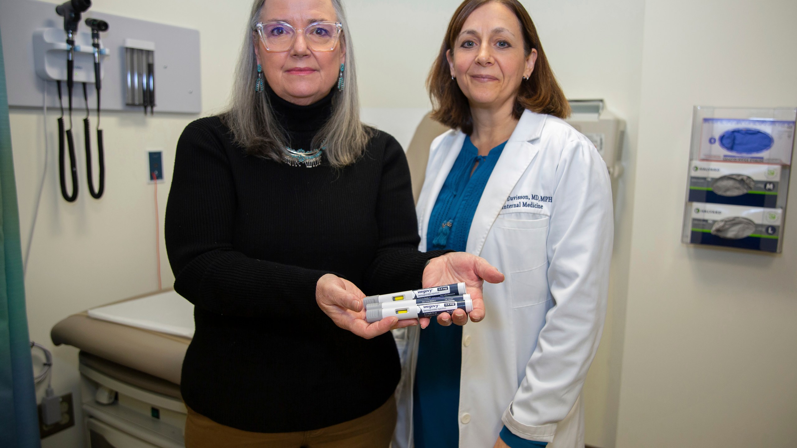 Patient Lory Osborn (left) holds Wegovy pens used in her treatment with Dr. Laura Davisson, director of the Medical Weight Management at West Virginia University in Morgantown, W.Va., Monday, Dec. 2, 2024. (AP Photo/Kathleen Batten)