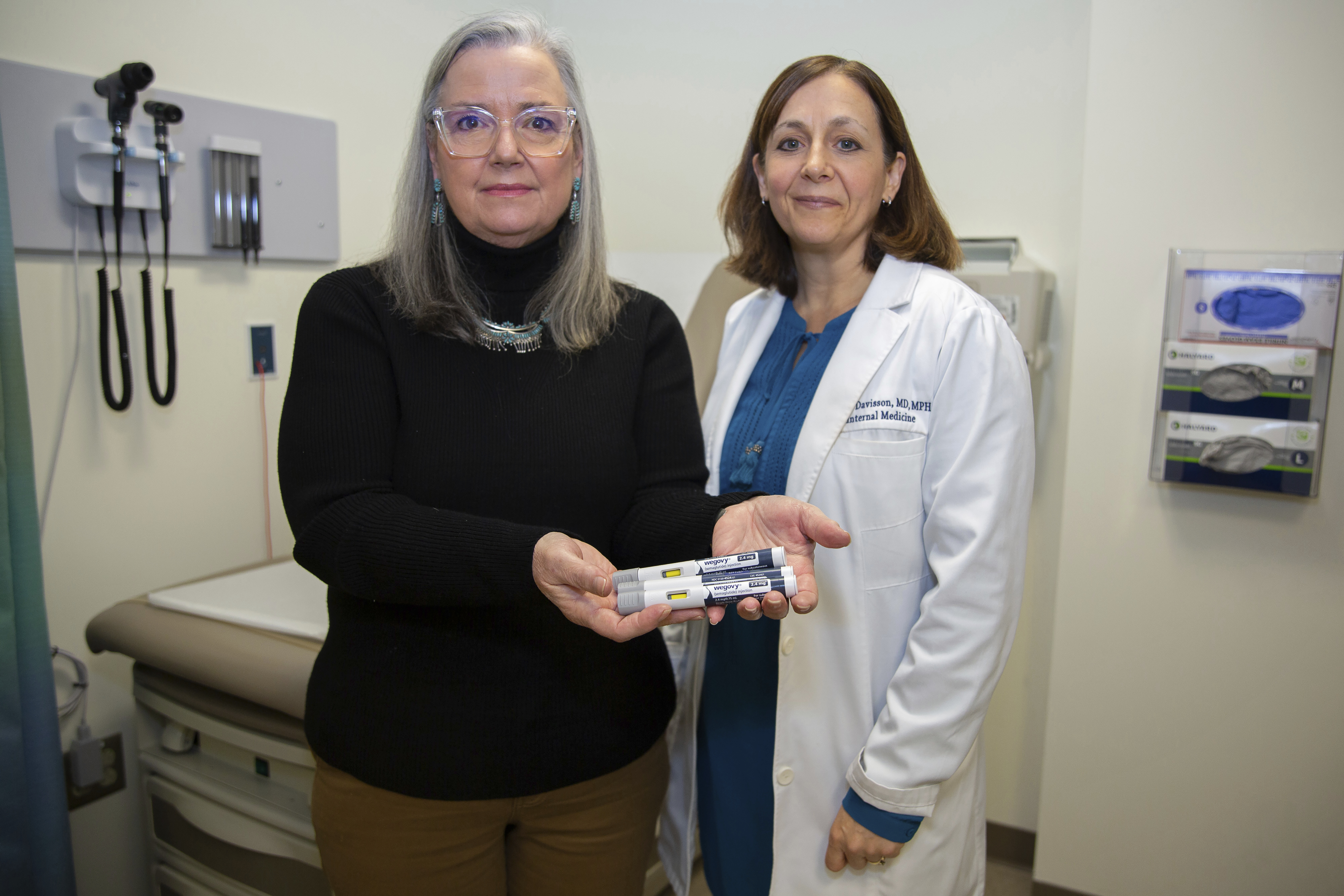 Patient Lory Osborn (left) holds Wegovy pens used in her treatment with Dr. Laura Davisson, director of the Medical Weight Management at West Virginia University in Morgantown, W.Va., Monday, Dec. 2, 2024. (AP Photo/Kathleen Batten)