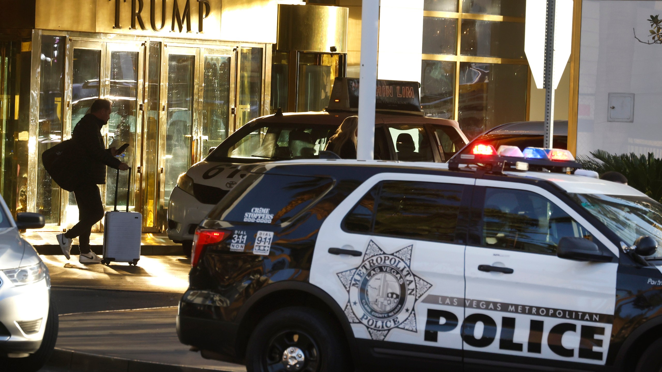 A guest is seen at the valet area outside Trump International Hotel in Las Vegas Thursday, Jan. 2, 2025. (Bizuayehu Tesfaye/Las Vegas Review-Journal via AP)