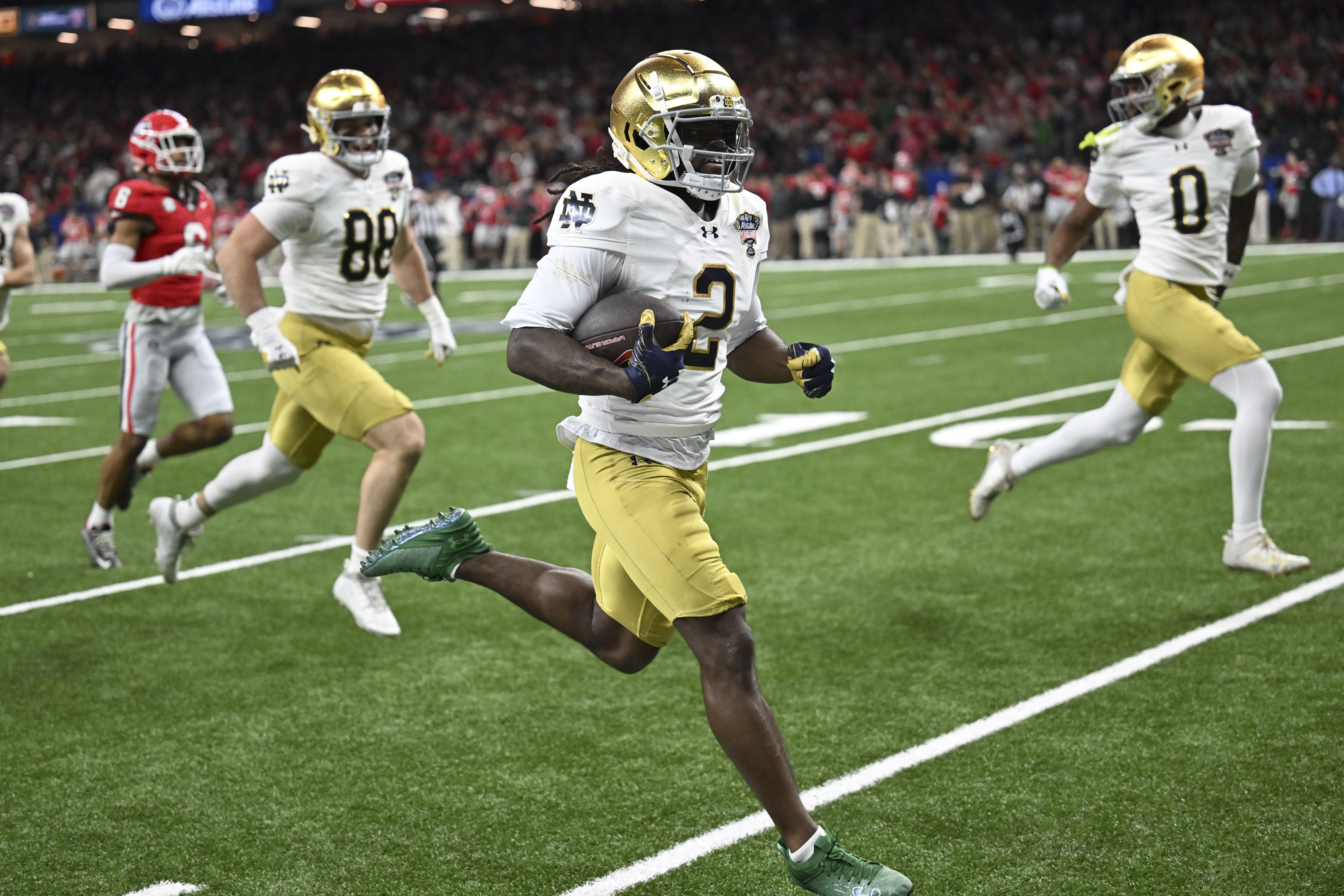 Notre Dame's Jayden Harrison (2) returns a kickoff 98 yards for a touchdown during the second half against Georgia in the quarterfinals of a College Football Playoff, Thursday, Jan. 2, 2025, in New Orleans. (AP Photo/Matthew Hinton)