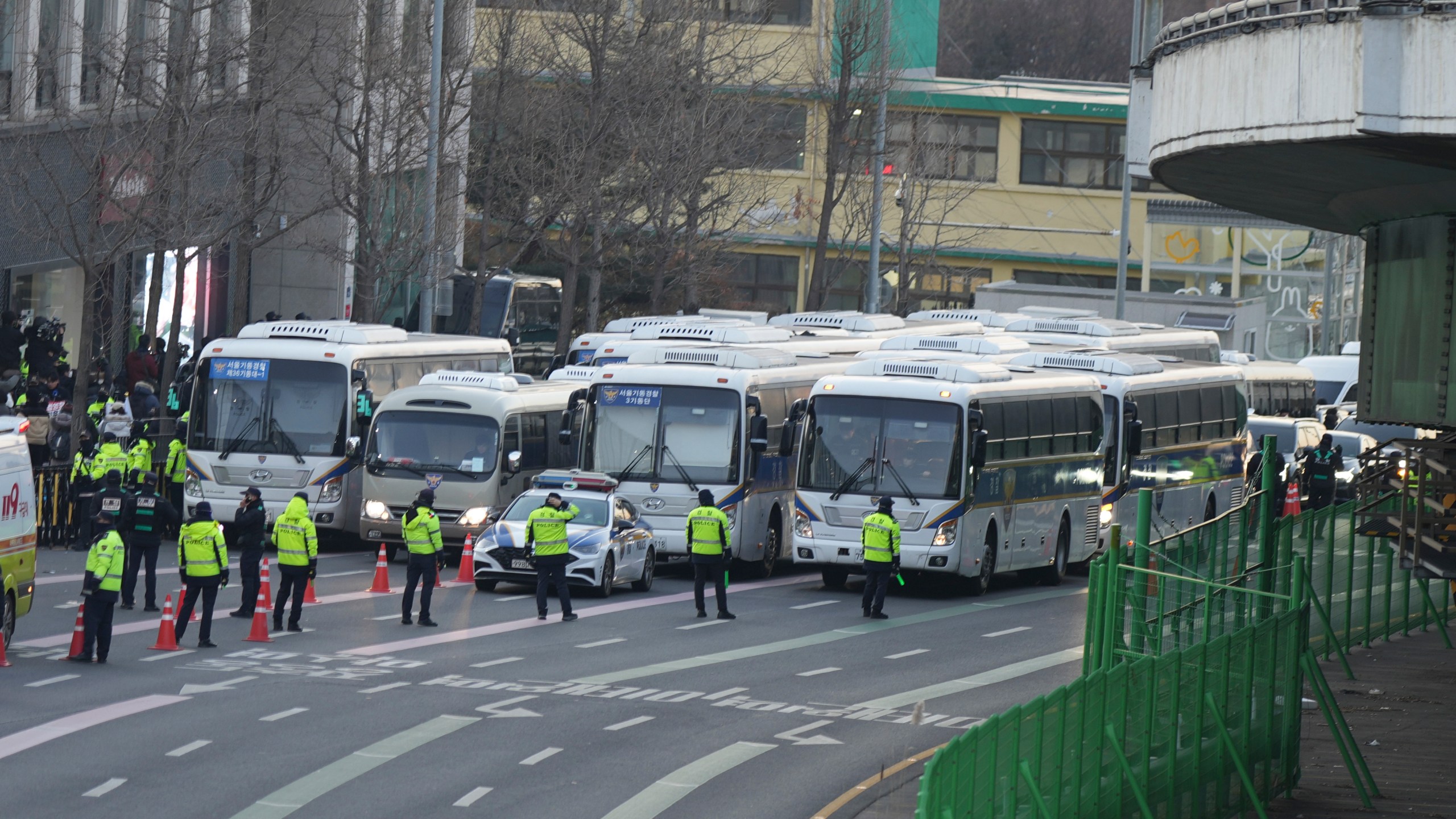 Police vehicles are seen near the gate of the presidential residence as supporters of impeached South Korean President Yoon Suk Yeol stage a rally to oppose a court having issued a warrant to detain Yoon, in Seoul, South Korea, Friday, Jan. 3, 2025. (AP Photo/Lee Jin-man)