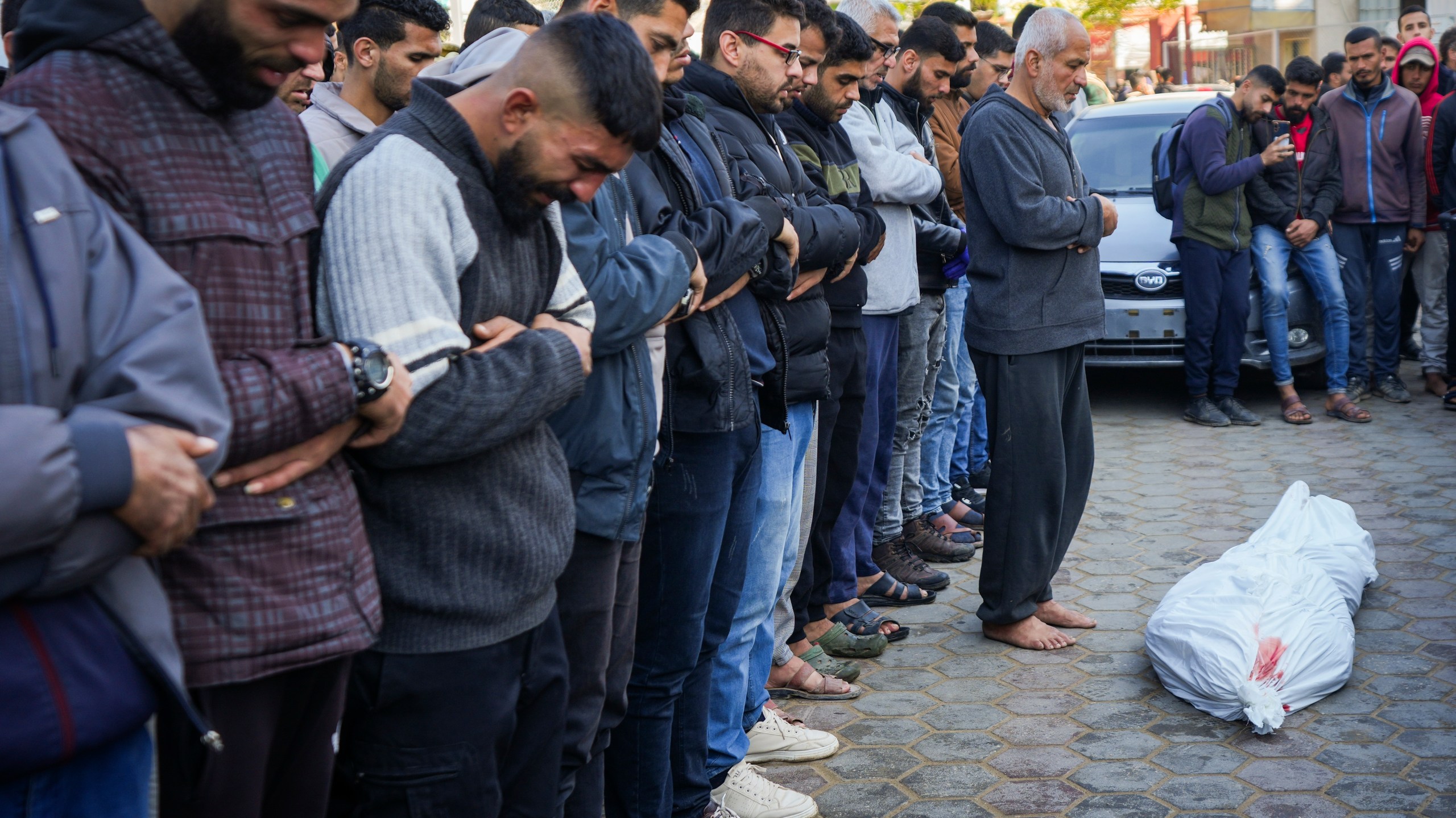 Palestinians pray over the body before the funeral of a man killed during an Israeli army strike in Deir al-Balah in the central Gaza Strip, Thursday Jan. 2, 2025.(AP Photo/Abdel Kareem Hana)