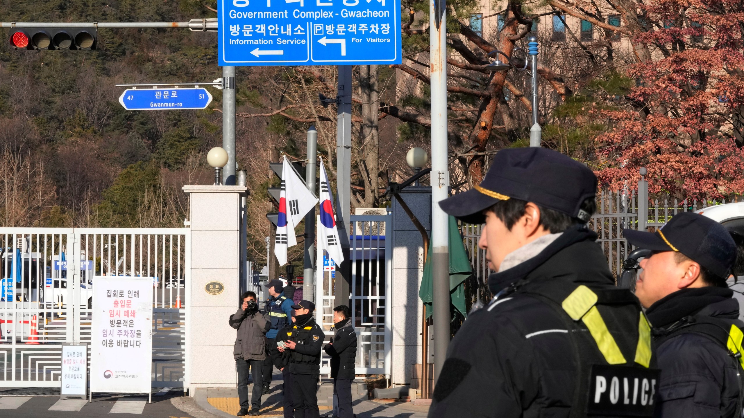 Police officers stand guard as they wait for the arrival of impeached South Korean President Yoon Suk Yeol near the Corruption Investigation Office for High-ranking Officials in Gwacheon, South Korea, Friday, Jan. 3, 2025. (AP Photo/Ahn Young-joon)