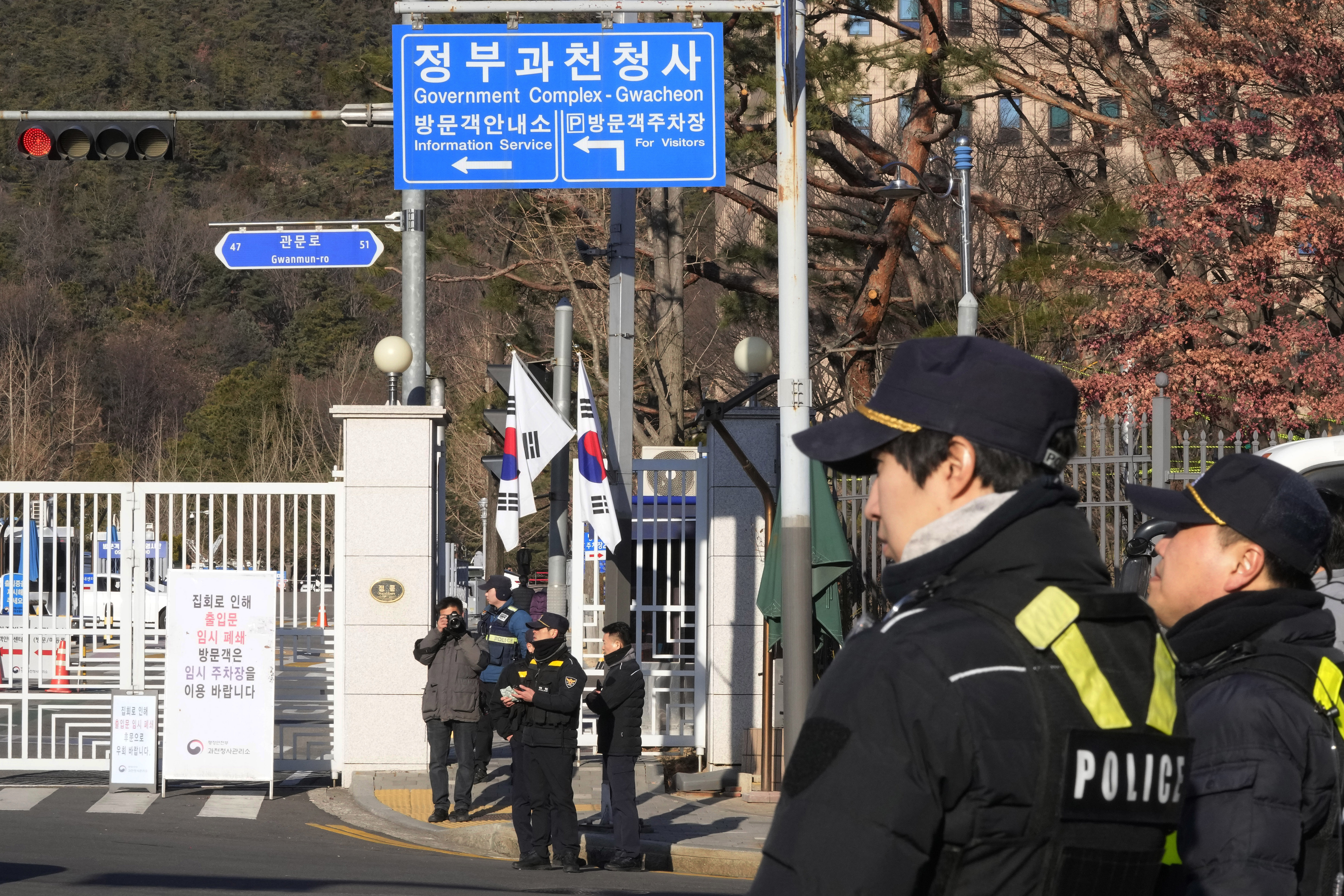 Police officers stand guard as they wait for the arrival of impeached South Korean President Yoon Suk Yeol near the Corruption Investigation Office for High-ranking Officials in Gwacheon, South Korea, Friday, Jan. 3, 2025. (AP Photo/Ahn Young-joon)