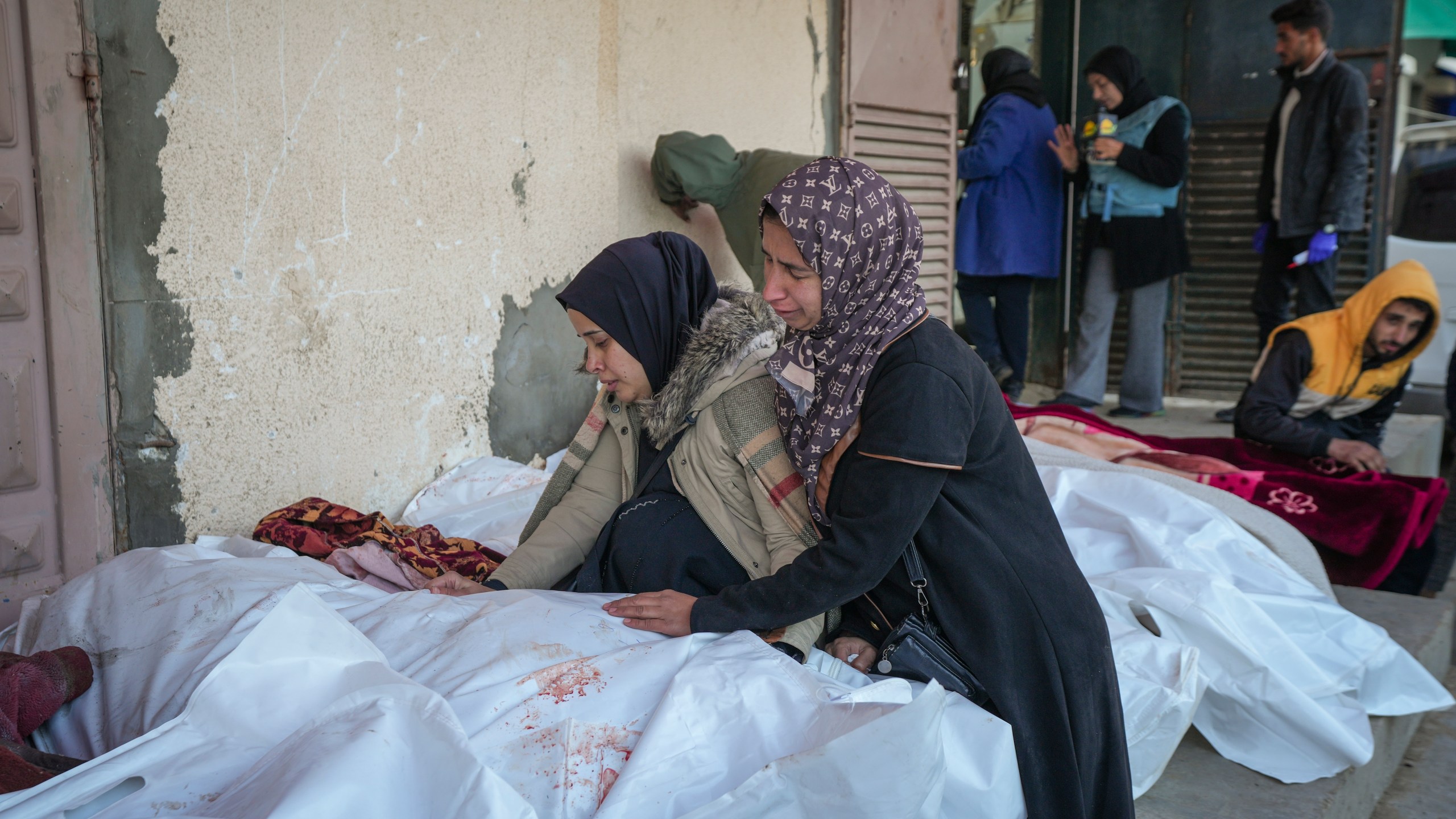 Relatives mourn over the bodies of victims of overnight Israeli army strikes at multiple locations in central Gaza Strip, at Al-Aqsa Martyrs Hospital in Deir al-Balah, Friday, Jan. 3, 2025. According to Al-Aqsa Martyrs Hospital, 30 people, including 10 women and 7 children, were killed in several attacks overnight in central Gaza. (AP Photo/Abdel Kareem Hana)