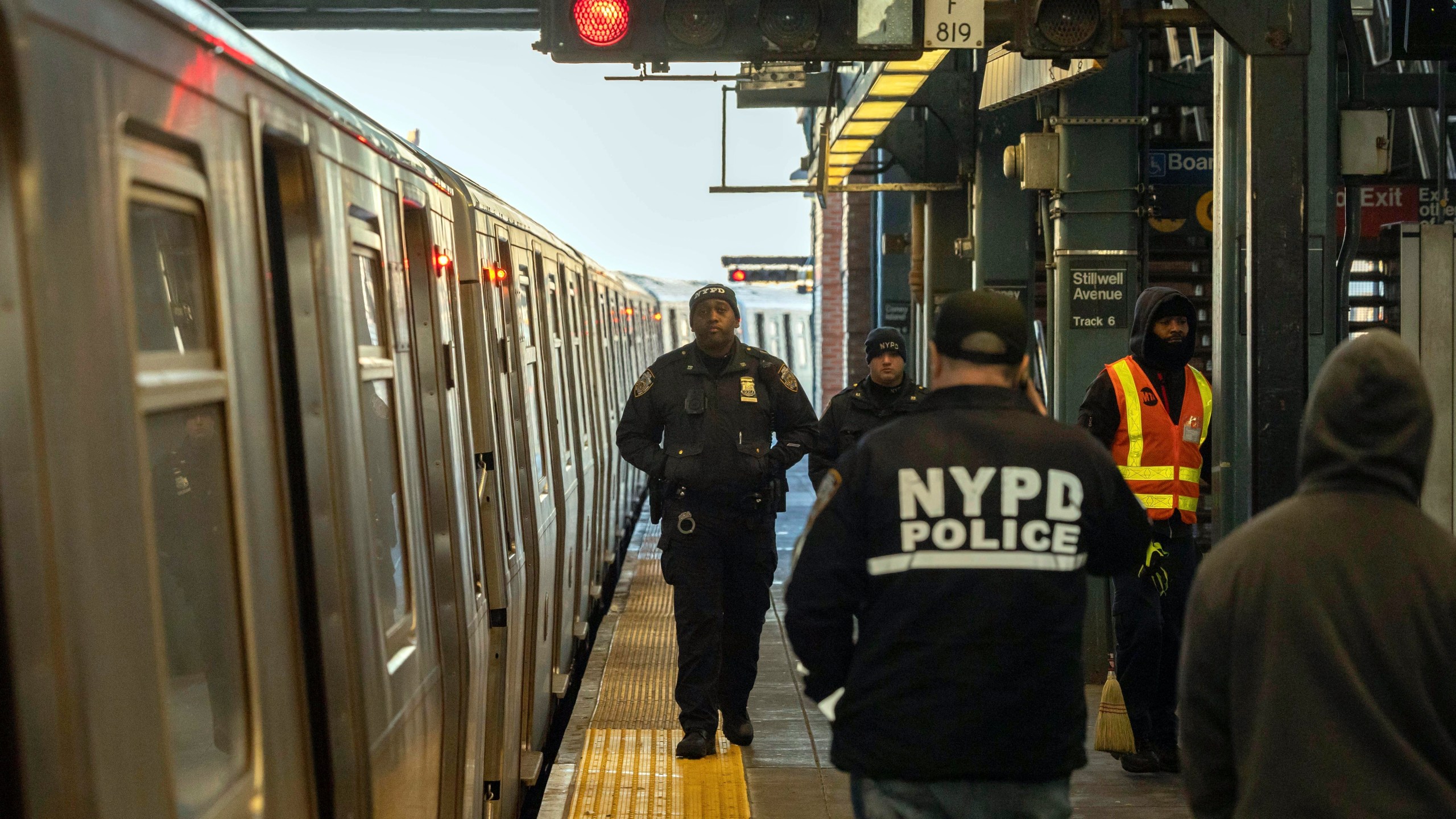 FILE - Police officers patrol the F train platform at the Coney Island-Stillwell Avenue Station, Thursday, Dec. 26, 2024, in New York. (AP Photo/Yuki Iwamura, File)