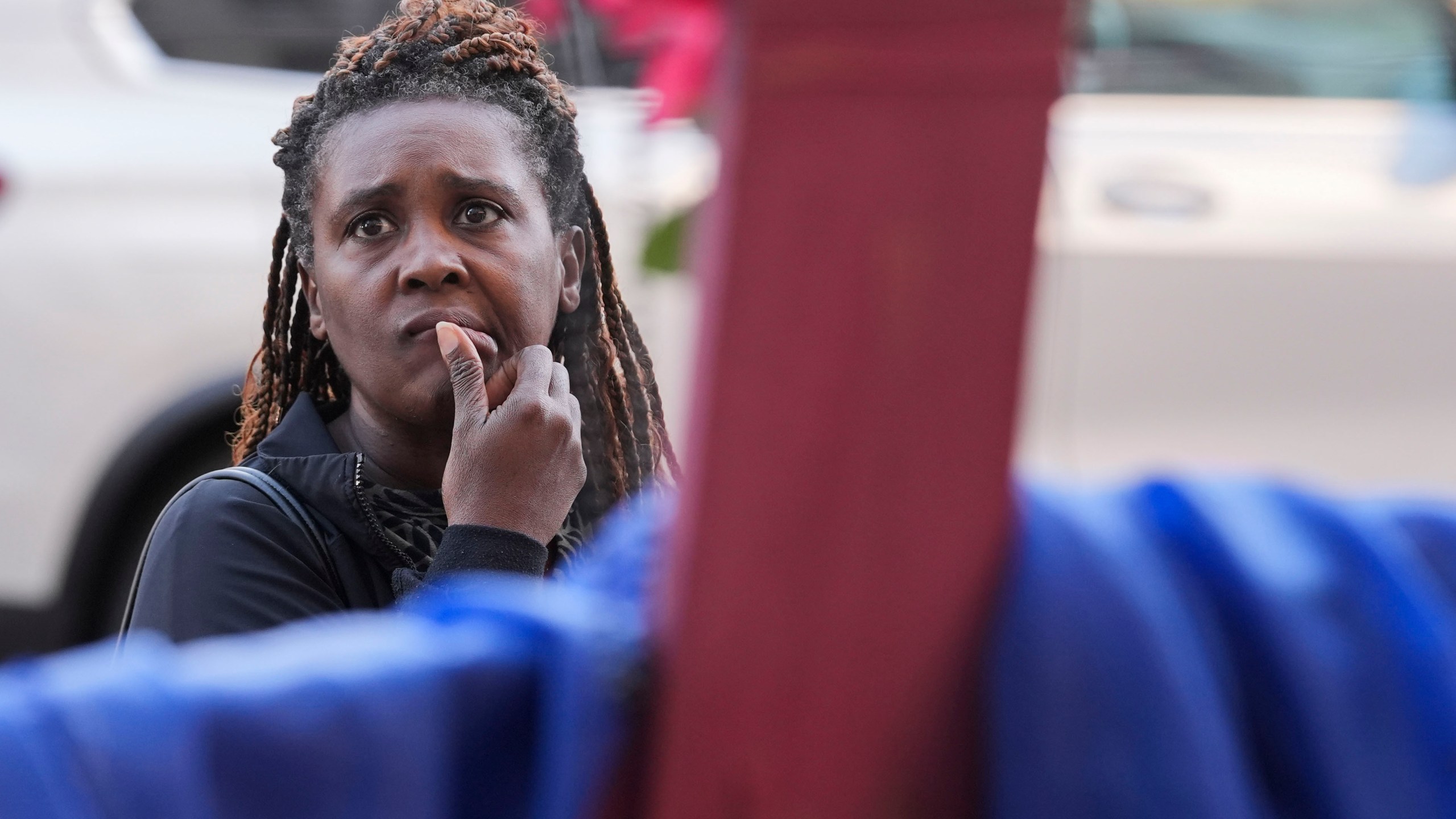 Katriel Faith Gibson, who lives nearby, reacts as she visits a memorial on Canal Street for the victims of a deadly truck attack on New Year's Day in New Orleans, Friday, Jan. 3, 2025. (AP Photo/Gerald Herbert)