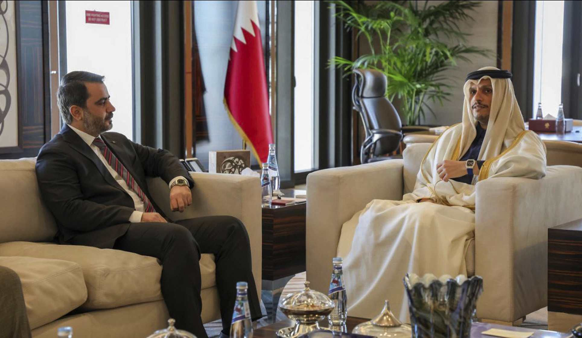 This photo released by the Syrian official news agency SANA, shows Syrian Foreign Minister Asaad al-Shibani, left, meeting with Qatari Prime Minister and Foreign Minister Mohammed bin Abdulrahman Al Thani, in Doha, Qatar, Sunday, Jan. 5, 2025. (SANA via AP)