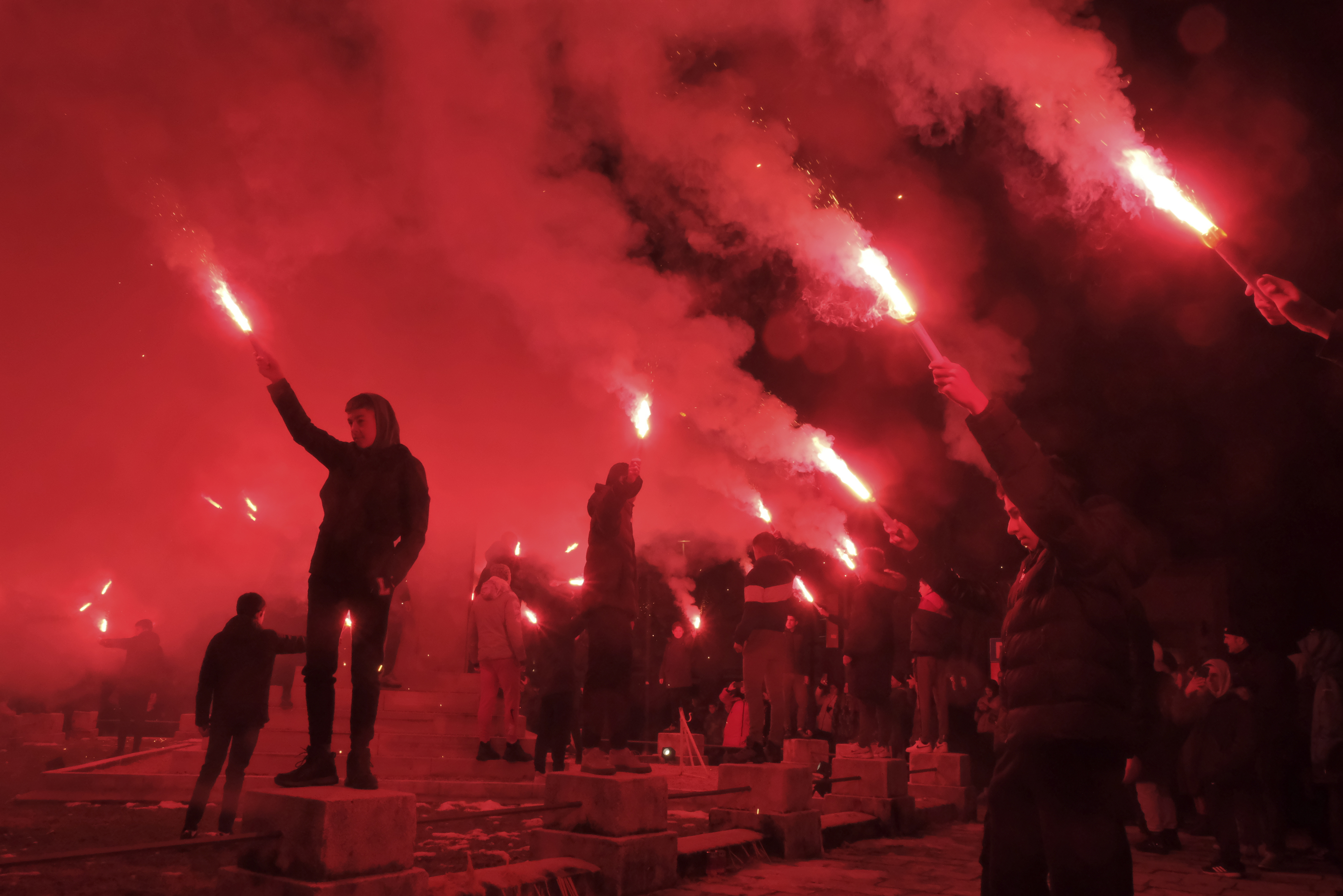 Children light torches during a protest demanding the resignations of top security officials over a shooting earlier this week in Cetinje, outside of Podogrica, Montenegro, Sunday, Jan 5, 2025. (AP Photo/Risto Bozovic)