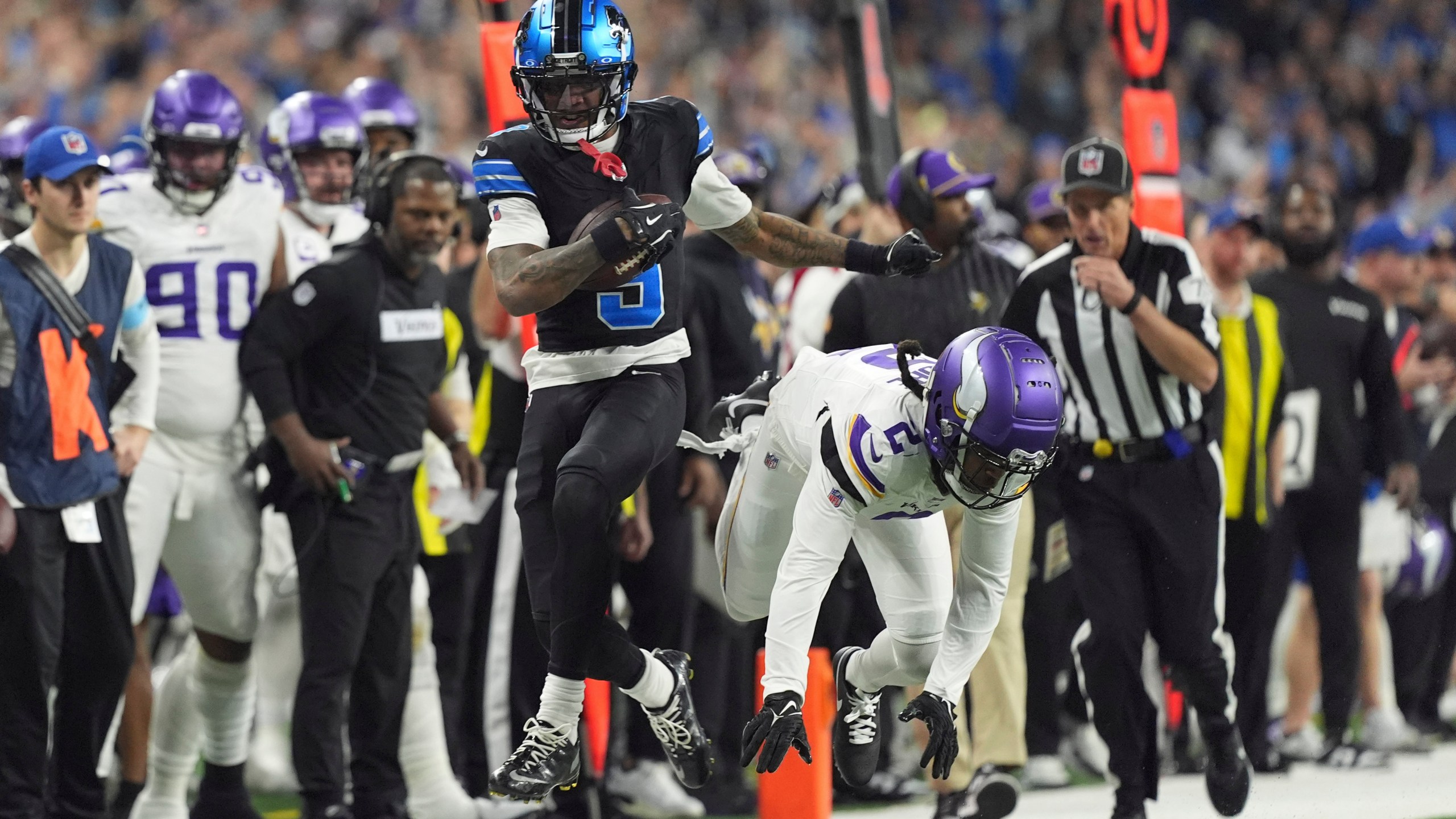 Detroit Lions wide receiver Jameson Williams (9) runs past Minnesota Vikings cornerback Stephon Gilmore (2) for a first down during the first half of an NFL football game Sunday, Jan. 5, 2025, in Detroit. (AP Photo/Charlie Riedel)