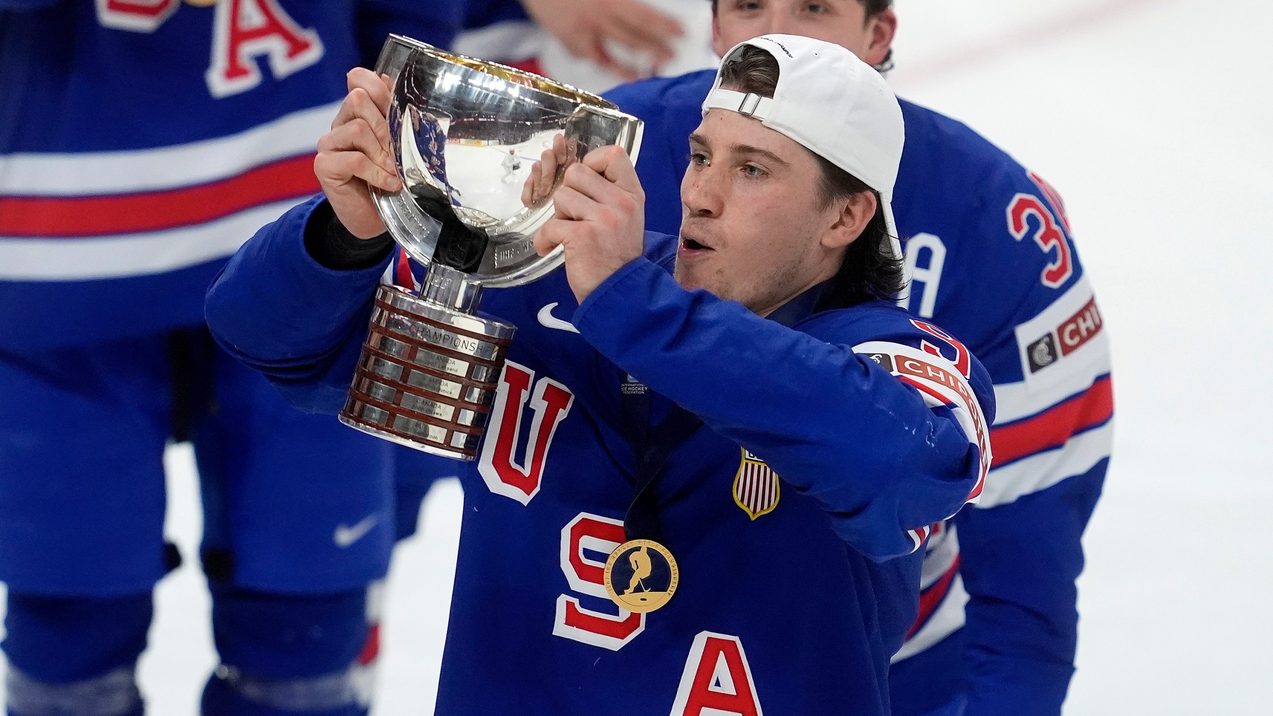 United States forward Ryan Leonard (9) hoists the trophy following their IIHF World Junior Hockey Championship gold medal game win over Finland in Ottawa, Ontario, Sunday, Jan. 5, 2025. (Adrian Wyld/The Canadian Press via AP)