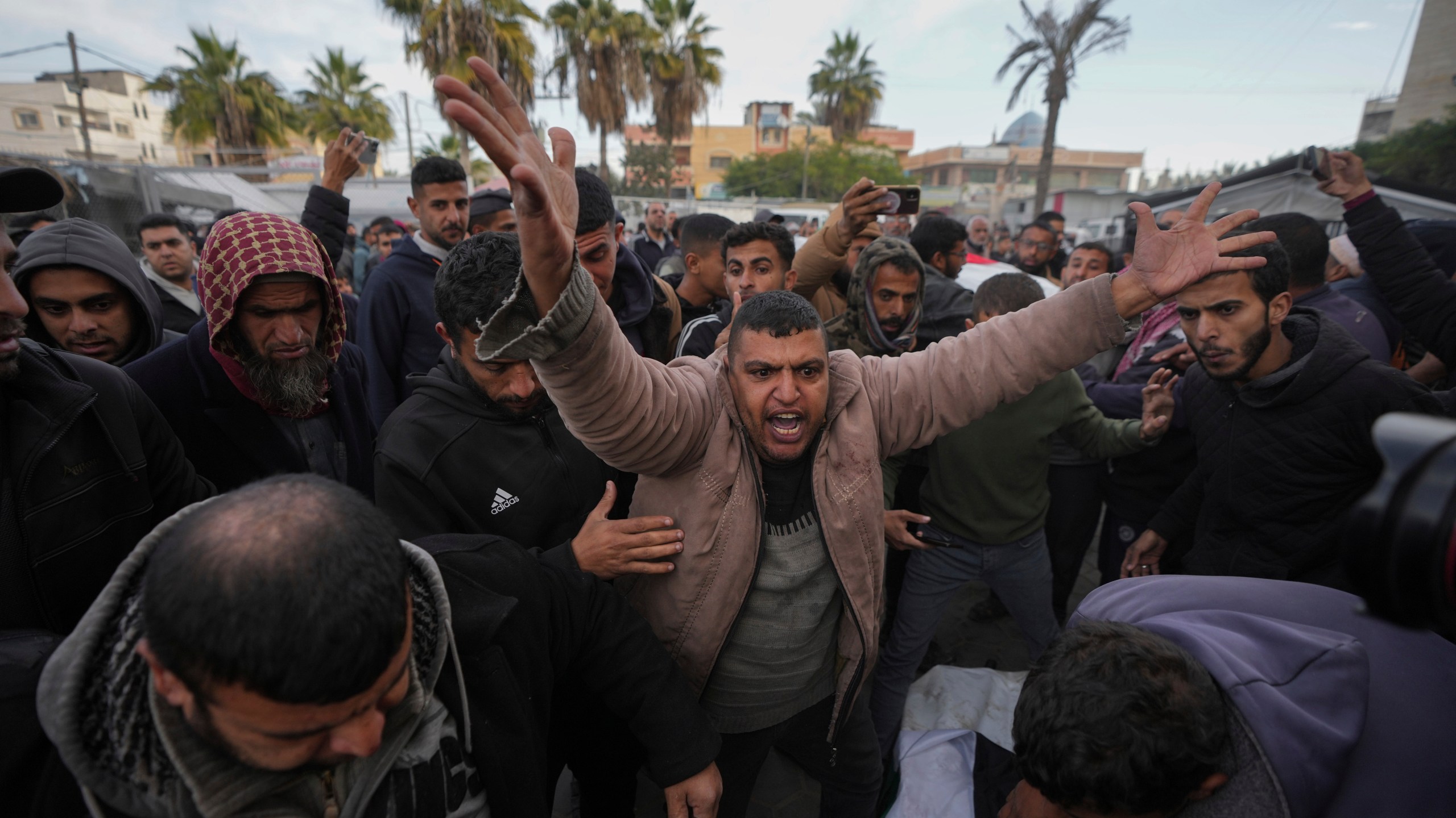 Palestinians mourn their relatives killed in the Israeli bombardment of the Gaza Strip, at Al-Aqsa Martyrs Hospital in Deir al-Balah, Sunday, Jan. 5, 2025. (AP Photo/Abdel Kareem Hana)