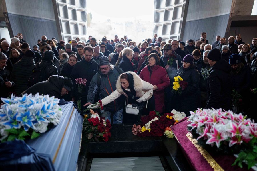 People attend the funeral ceremony of neurobiologist Ihor Zyma and his wife, biologist Olesia Sokur, who were killed by a Russian strike on Jan. 1, in Kyiv Monday, Jan. 6, 2025. (AP Photo/Evgeniy Maloletka)