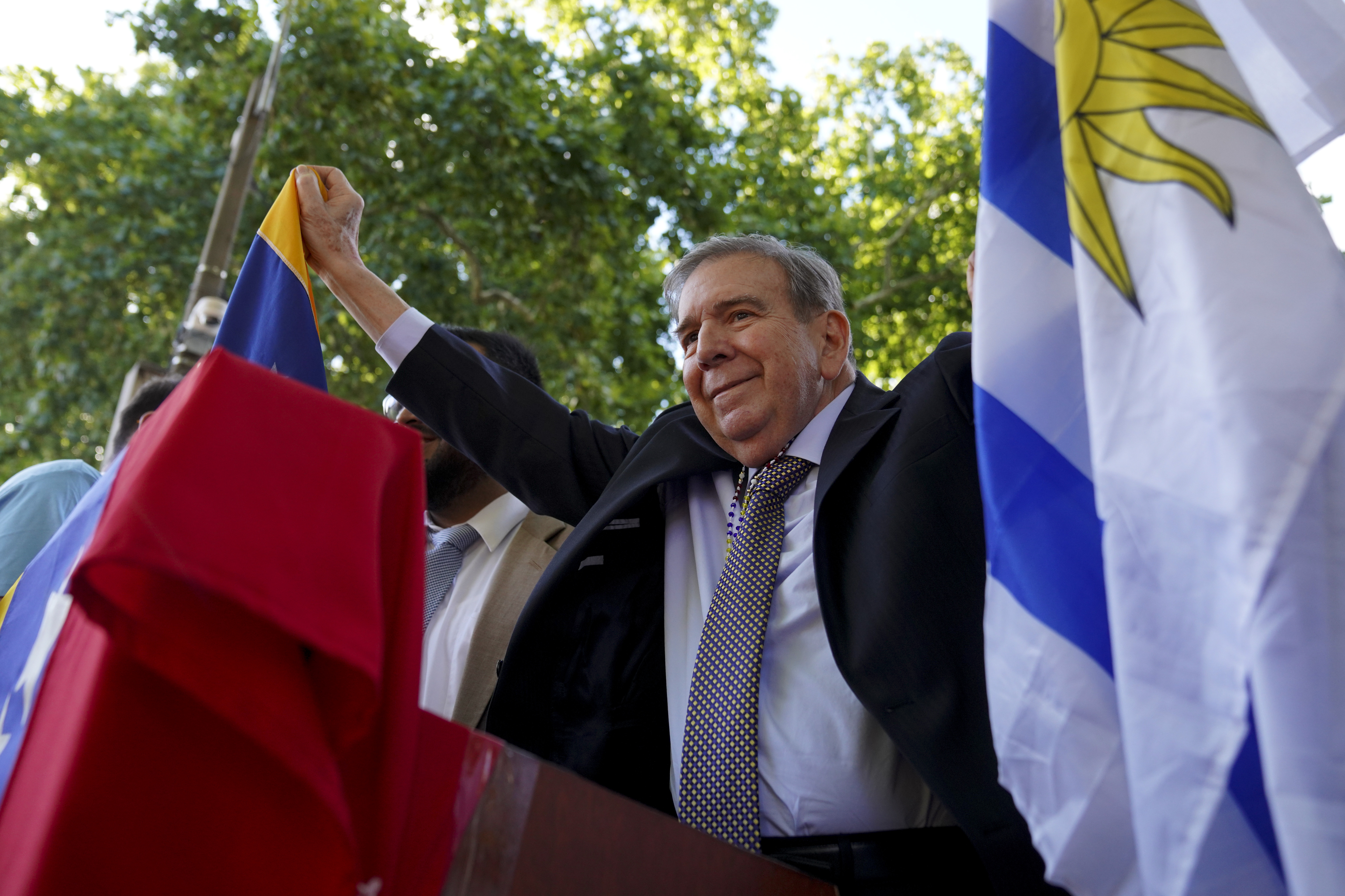 Venezuela's opposition leader Edmundo Gonzalez Urrutia holds an Uruguayan and a Venezuelan flag outside the government residence in Montevideo, Uruguay, Saturday, Jan. 4, 2025. Gonzalez, who claims he won the 2024 presidential election and is recognized by some countries as the legitimate president-elect, traveled from exile in Madrid to Argentina and Uruguay. (AP Photo/Matilde Campodonico)