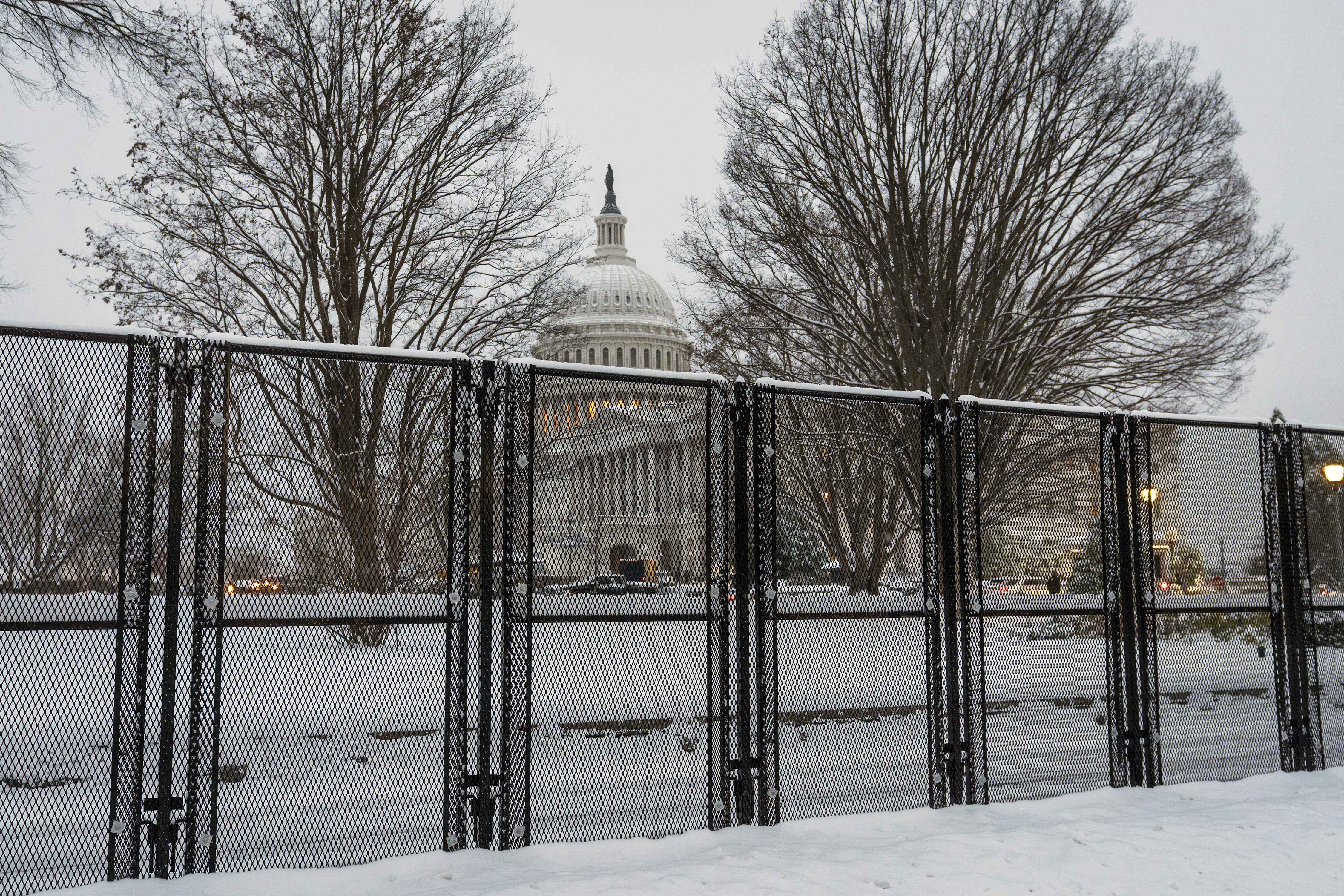 Security fencing surrounds Capitol Hill as snow blankets the region ahead of a joint session of Congress to certify the votes from the Electoral College in the presidential election, in Washington, Monday, Jan. 6, 2025. (AP Photo/J. Scott Applewhite)