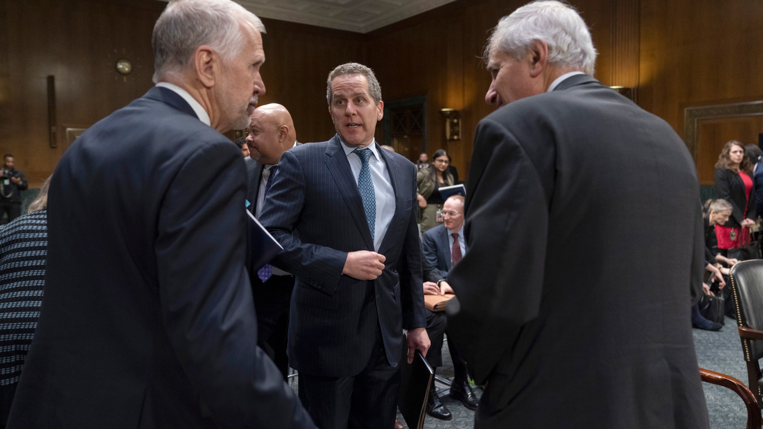 FILE - Michael Barr, Vice Chairman For Supervision of the Board of Governors of the Federal Reserve System, center, stands along with Sen. Thom Tillis, R-N.C., left, and Federal Deposit Insurance Corporation (FDIC) Chairman Martin Gruenberg as a Senate Banking, Housing and Urban Affairs hearing concludes on Capitol Hill, in Washington, March 28, 2023. (AP Photo/Manuel Balce Ceneta, File)