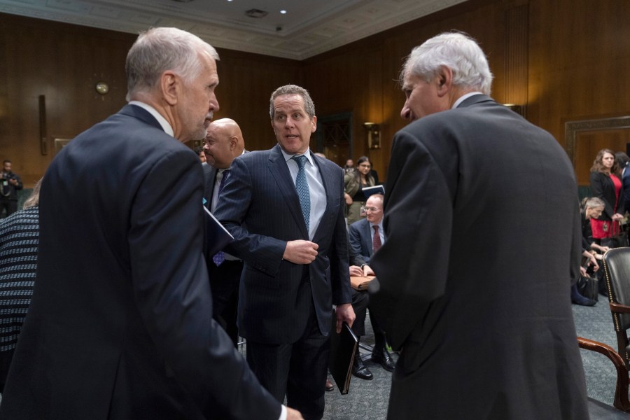 FILE - Michael Barr, Vice Chairman For Supervision of the Board of Governors of the Federal Reserve System, center, stands along with Sen. Thom Tillis, R-N.C., left, and Federal Deposit Insurance Corporation (FDIC) Chairman Martin Gruenberg as a Senate Banking, Housing and Urban Affairs hearing concludes on Capitol Hill, in Washington, March 28, 2023. (AP Photo/Manuel Balce Ceneta, File)