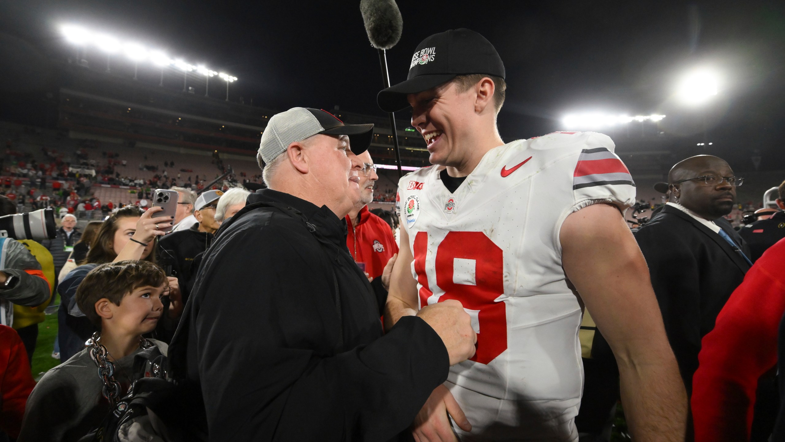 Ohio State offensive coordinator Chip Kelly, left, celebrates with quarterback Will Howard (18) after the quarterfinals of the Rose Bowl College Football Playoff against Oregon, Wednesday, Jan. 1, 2025, in Pasadena, Calif. (AP Photo/Kyusung Gong)