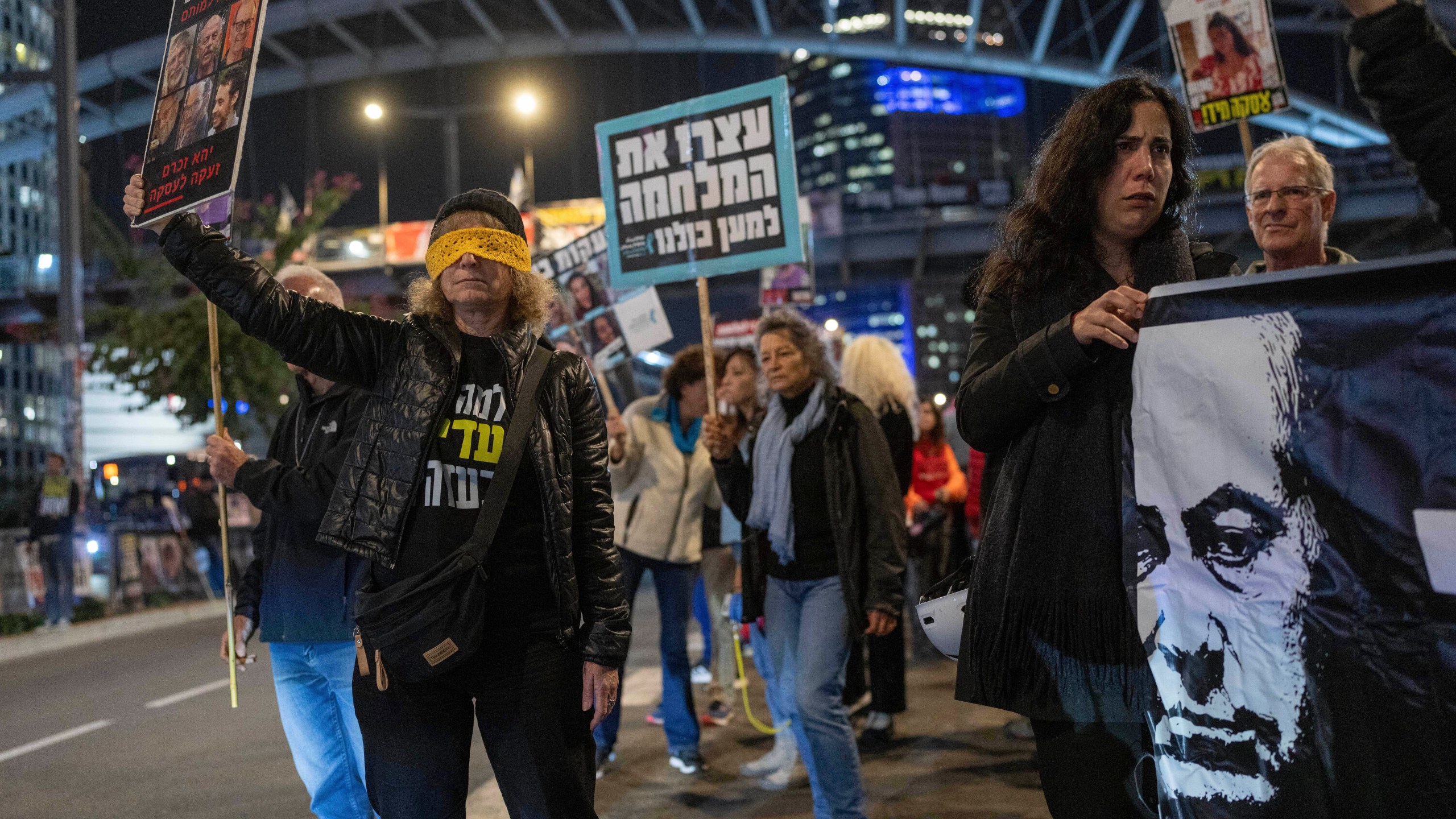 Israelis protest against Prime Minister Benjamin Netanyahu's government and call for the release of hostages, held in the Gaza Strip by the Hamas militant group, in Tel Aviv, Israel, Monday, Jan. 6, 2025. (AP Photo/Ohad Zwigenberg)