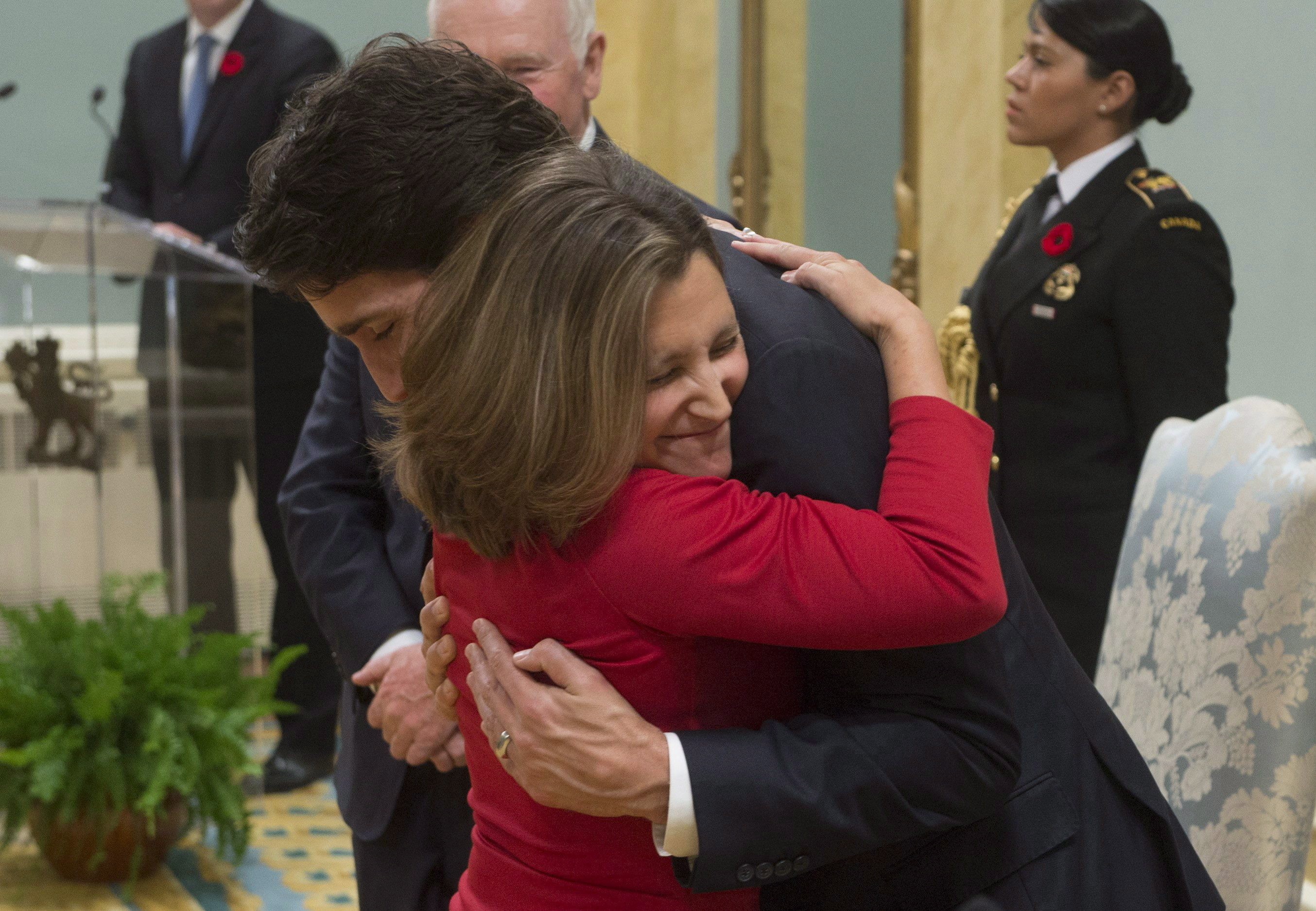 FILE - Minister of International Trade Chrystia Freeland gives Prime Minister Justin Trudeau a hug after being sworn in during ceremonies at Rideau Hall, on Nov. 4, 2015, in Ottawa. (Adrian Wyld/The Canadian Press via AP, File)