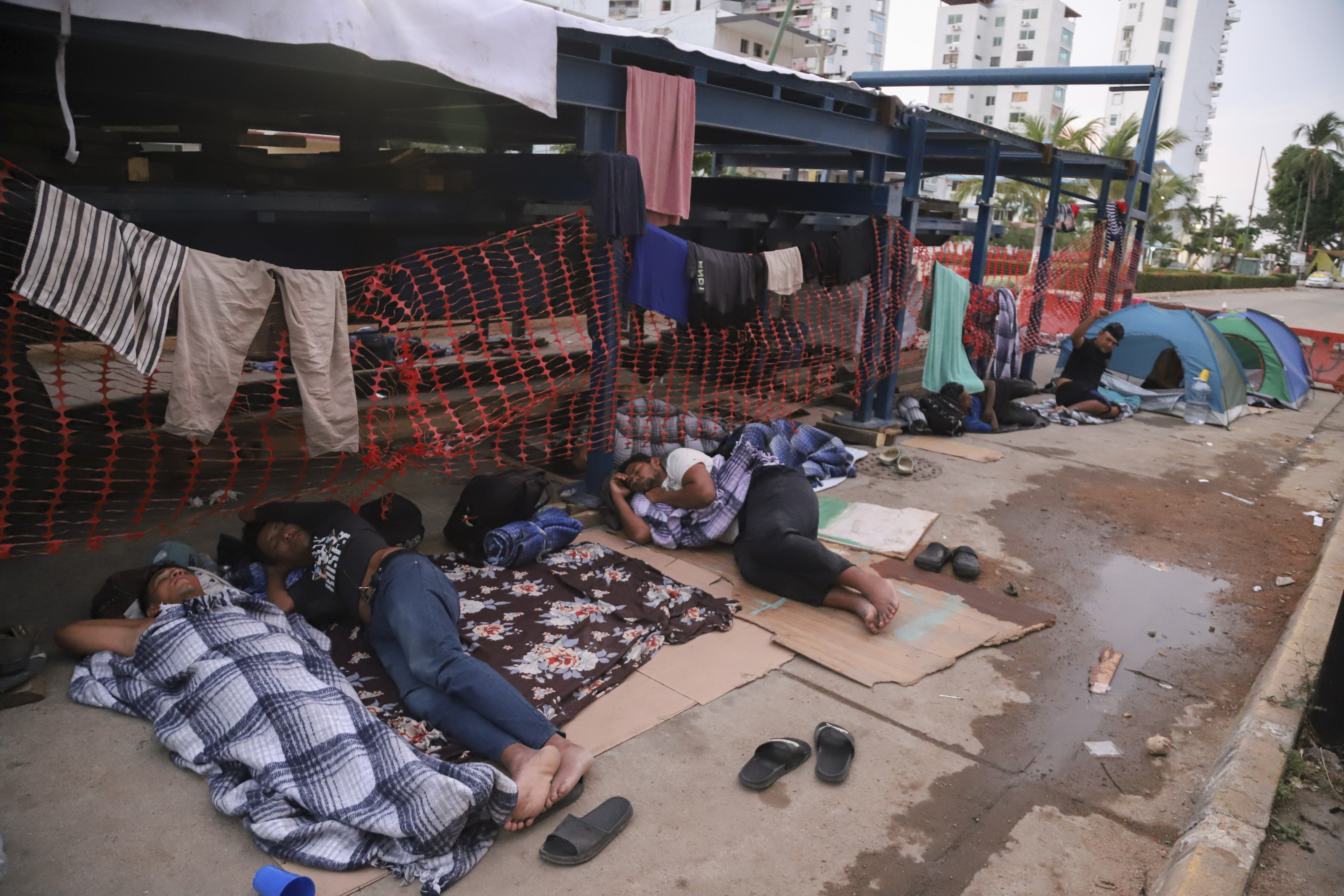 Migrants sleep on the side of a street in Acapulco, Mexico, Monday, Jan. 6, 2025. (AP Photo/Bernardino Hernandez)