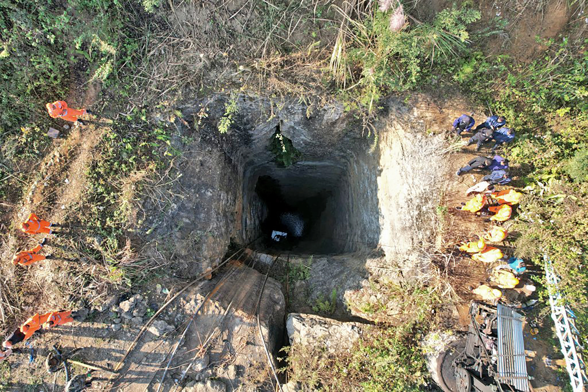 This image provided by Indian Army shows rescue workers standing around a coal mine where at least nine workers are trapped, in Umrangso area of Dimapur Hasao district in northeastern state of Assam, India, Tuesday, Jan. 7, 2025. (Indian Army via AP)